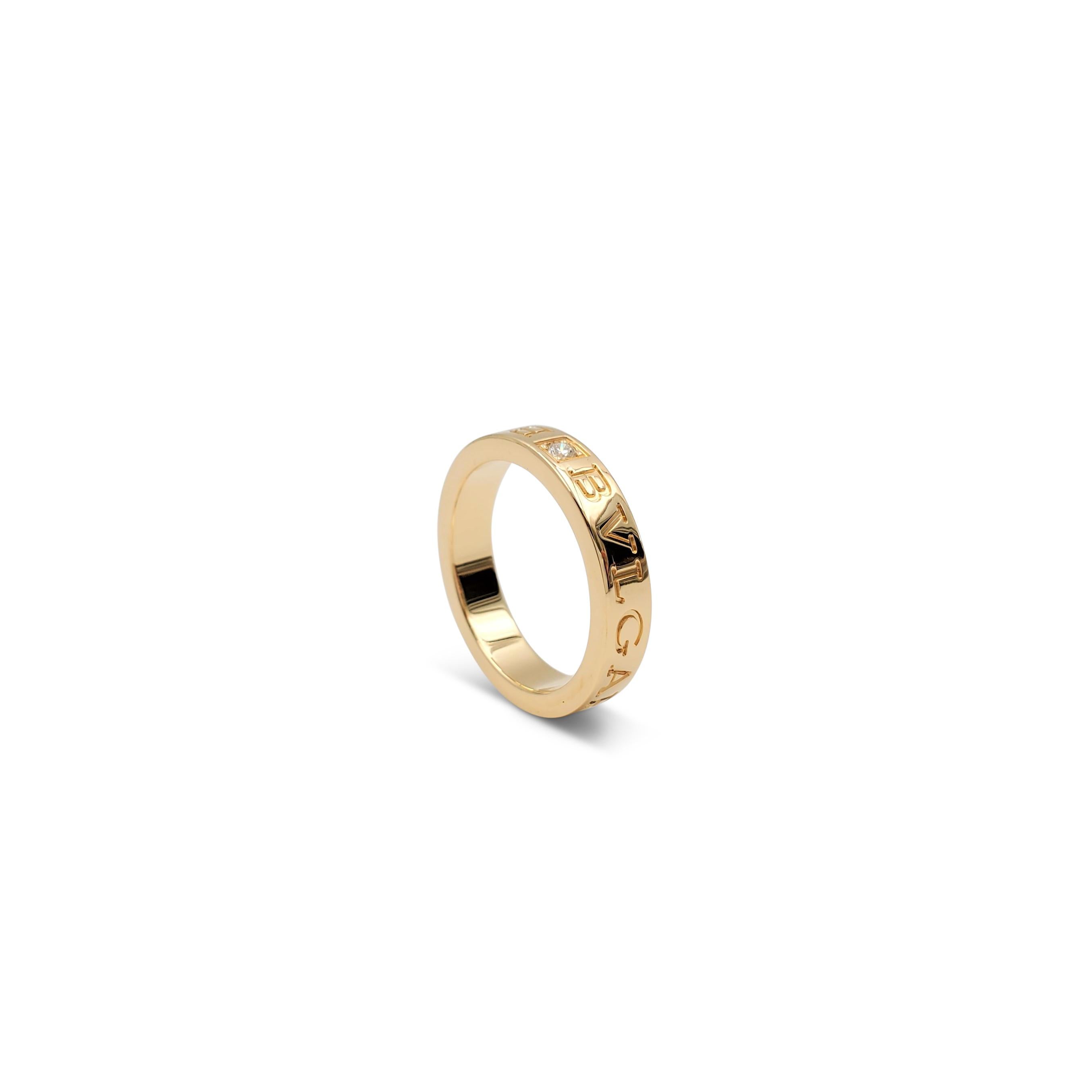 Authentic Bvlgari ring from the 'Bvlgari Bvlgari' collection crafted in 18 karat yellow gold and set with one round brilliant cut diamond weighing an estimated .04ct. Engraved BVLGARI BVLGARI on the outside of the band.  Size 6.  Stamped AU750, Made