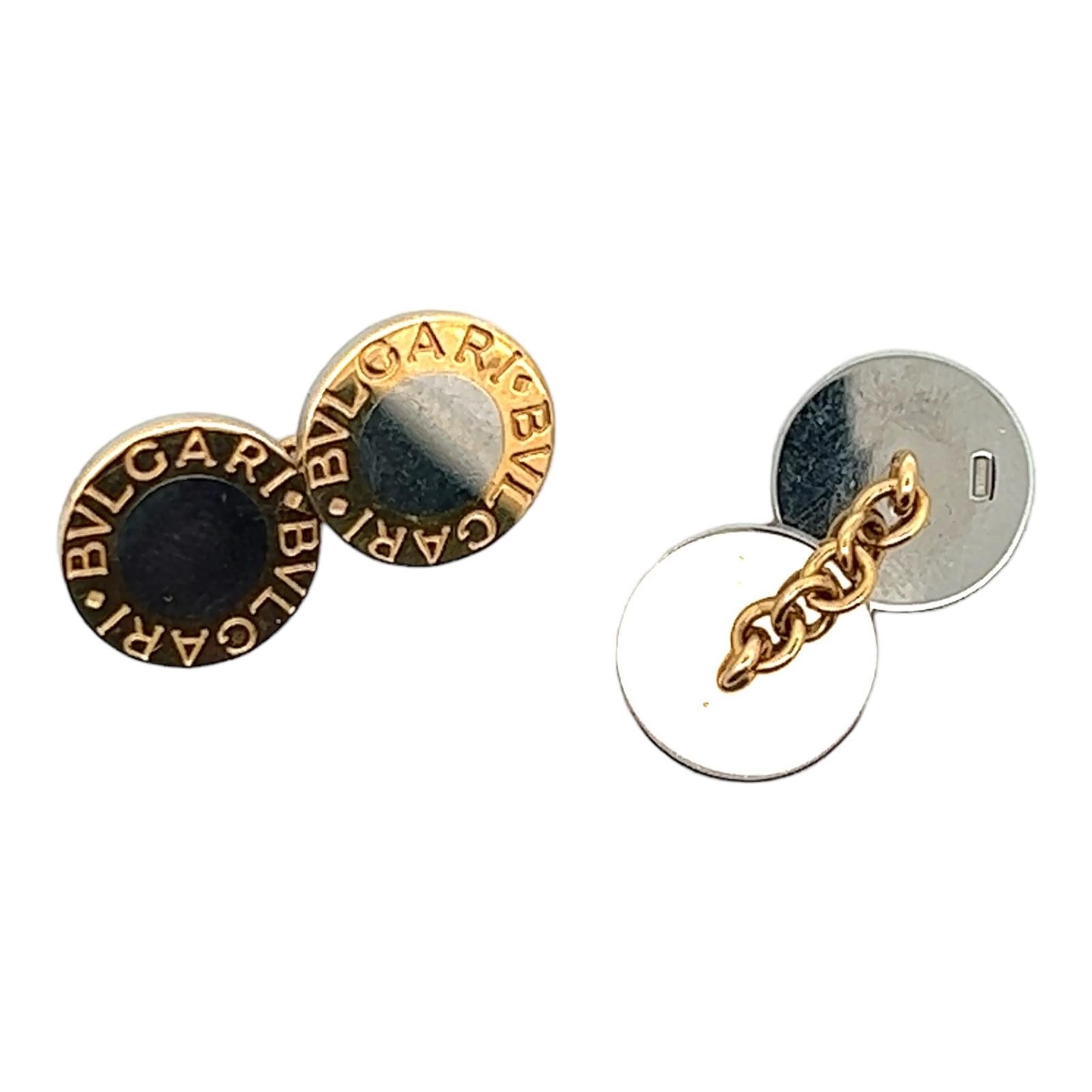 Iconic Bvlgari men's cufflinks crafted in 18 karat yellow gold and stainless steel. The chain cufflinks measure 13 x 13 mm and come in original Bvlgari box. 