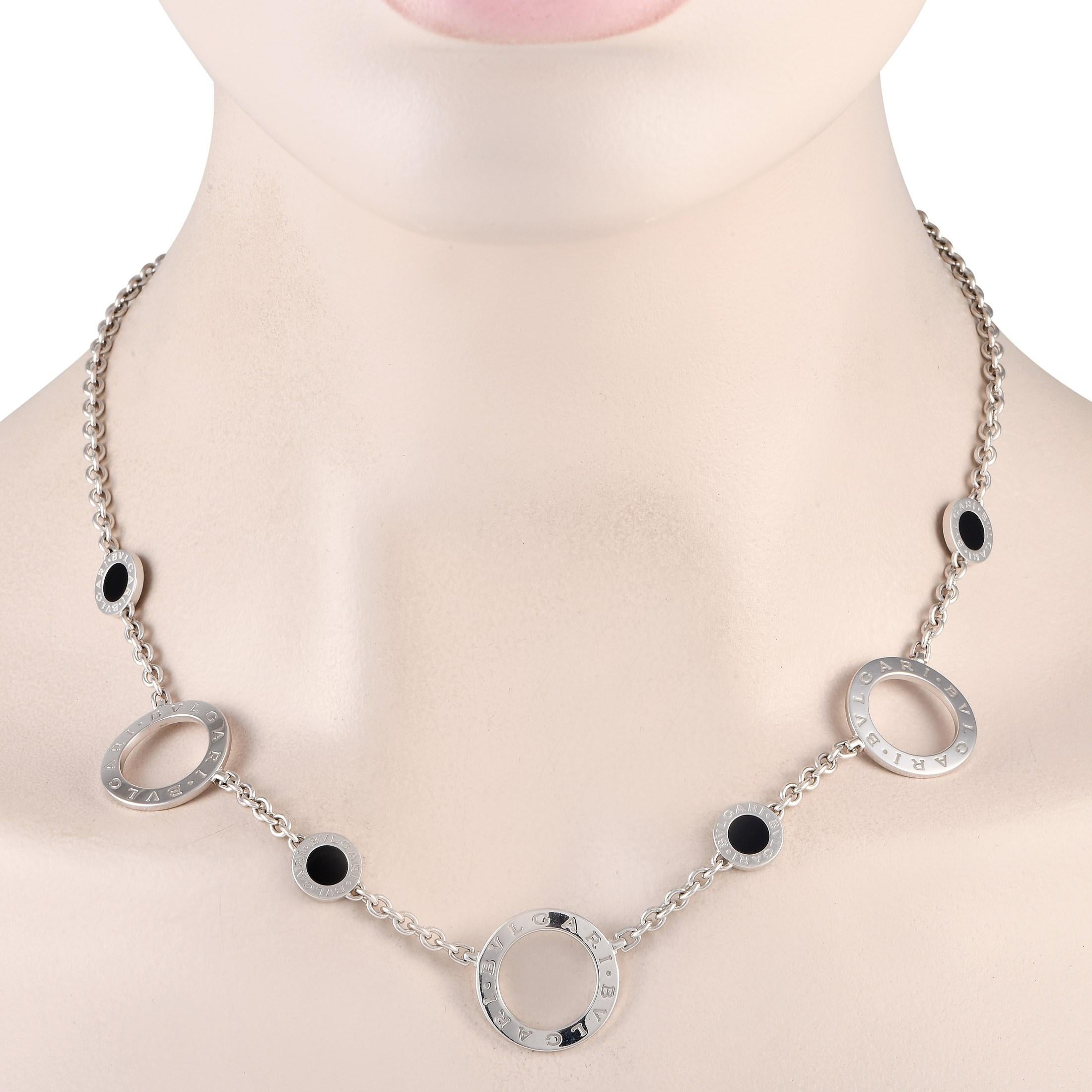 The Bvlgari Bvlgari 18K White Gold Onyx Necklace is expertly crafted in 18K white gold. It features three hoops with the Bvlgari Bvlgari engraved text logo. Four small discs with circular onyx plaques sit in between each white gold hoop. The