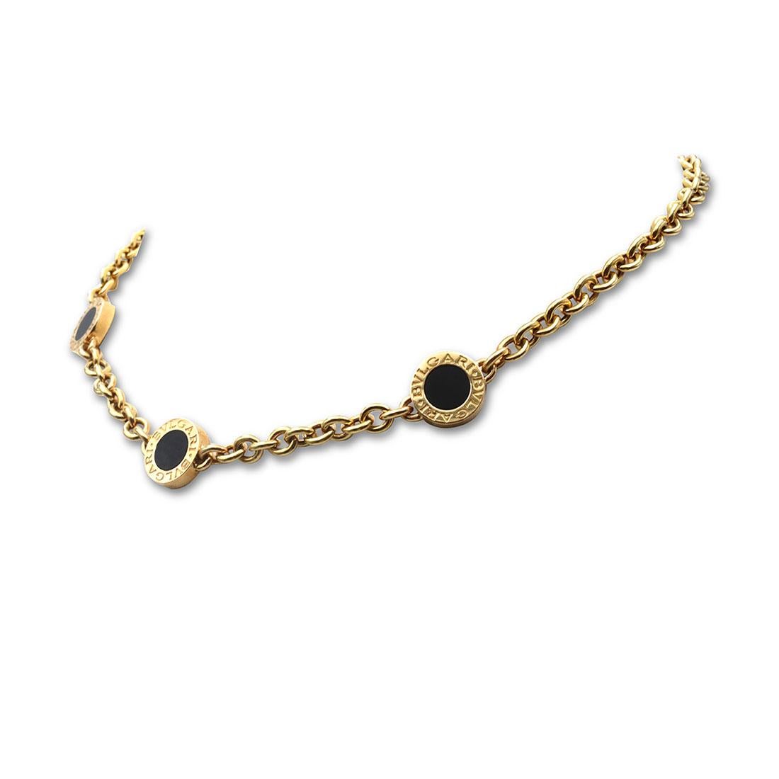 Authentic Bvlgari station necklace from the Bvlgari-Bvlgari collection crafted in 18 karat yellow gold. The cable link chain necklace features three round stations set with onyx. Signed Bvlgari, Made in Italy, 750 with hallmarks. The necklace is not