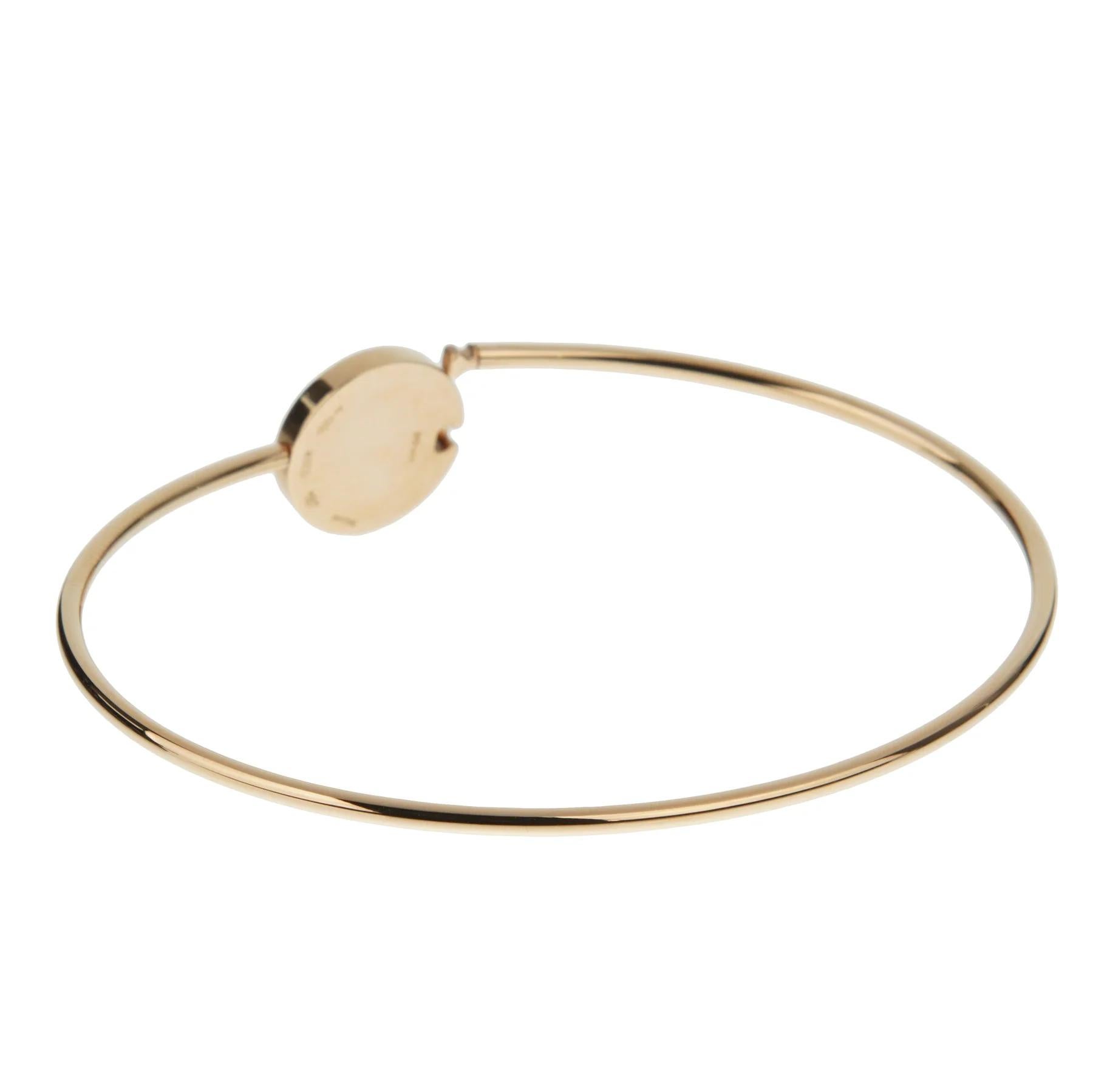 This stunning bangle bracelet is crafted from 18kt rose gold, known for its warm, romantic hue that adds a touch of sophistication to any ensemble. The rose gold is polished to a high shine, creating a sleek and refined finish that enhances the