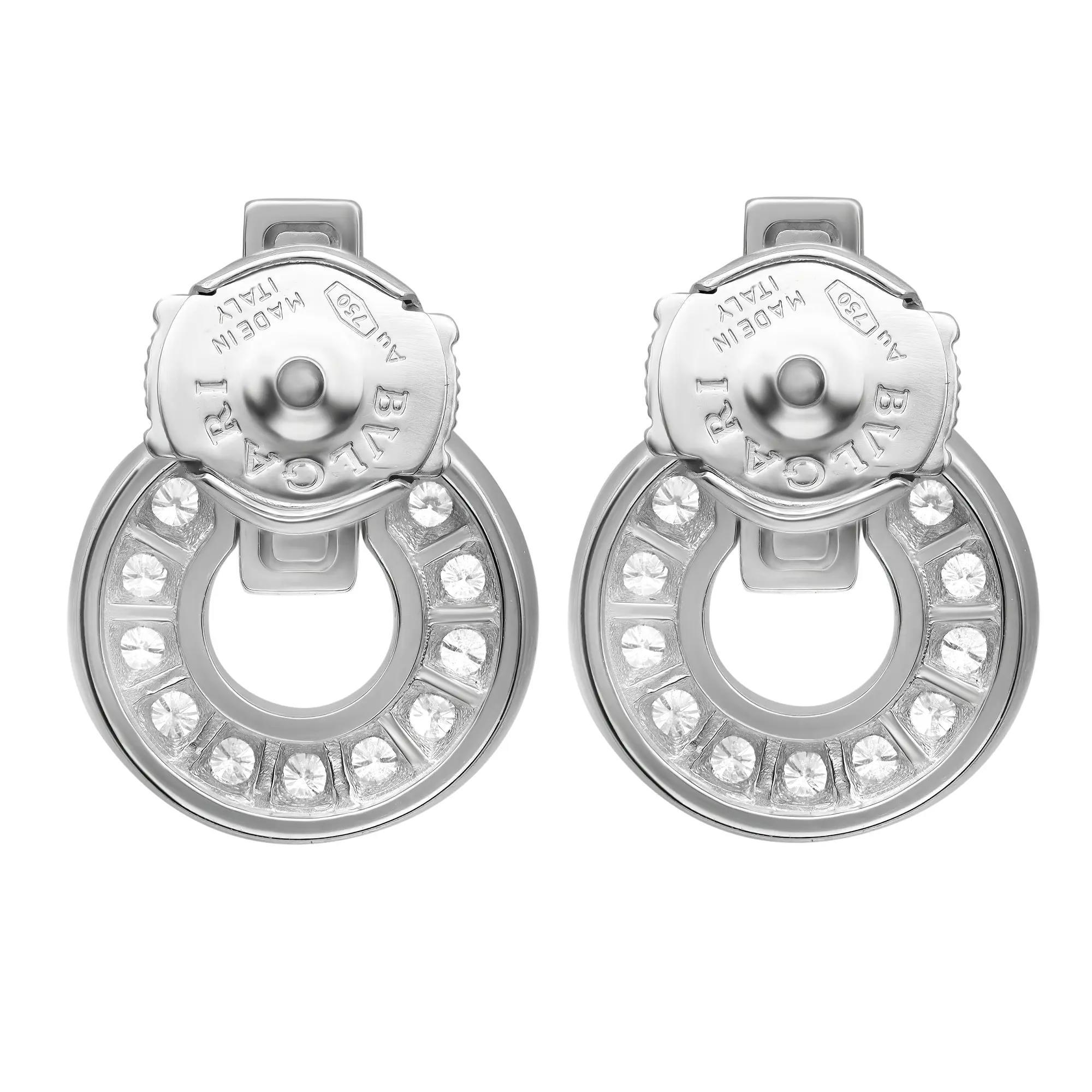 Beautiful and contemporary statement of sophistication, these Bvlgari Bvlgari diamond earrings are crafted in lustrous 18K white gold. It features a Bvlgari logo engraved earring top attached to an iconic circular motif with an openwork design