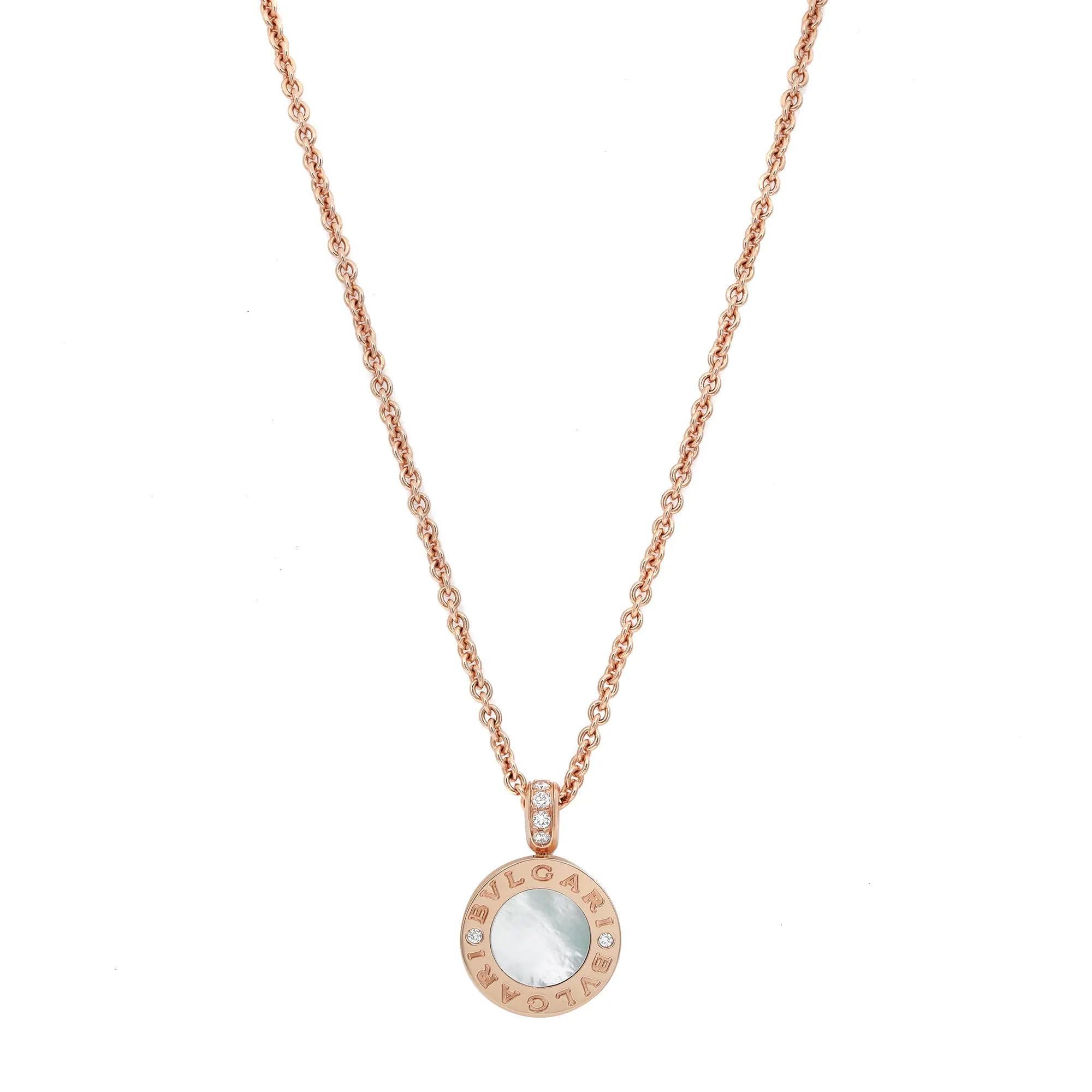 Fusion élégante de culture et de modernité, ce collier pendentif BVLGARI est réalisé en or rose 18 carats lustré. Il comporte un pendentif rond avec le logo Bvlgari gravé et des diamants taillés en rond des deux côtés encadrant des pierres