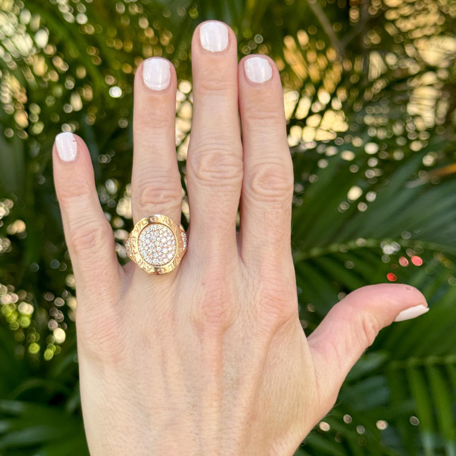 This stunning 18k rose gold BVLGARI BVLGARI pavé diamond ring features approximately 0.95 carats total weight of round brilliant diamonds in F-G color and VS clarity, offering exceptional brilliance and sparkle. The curved top, measuring 20 x 20mm,