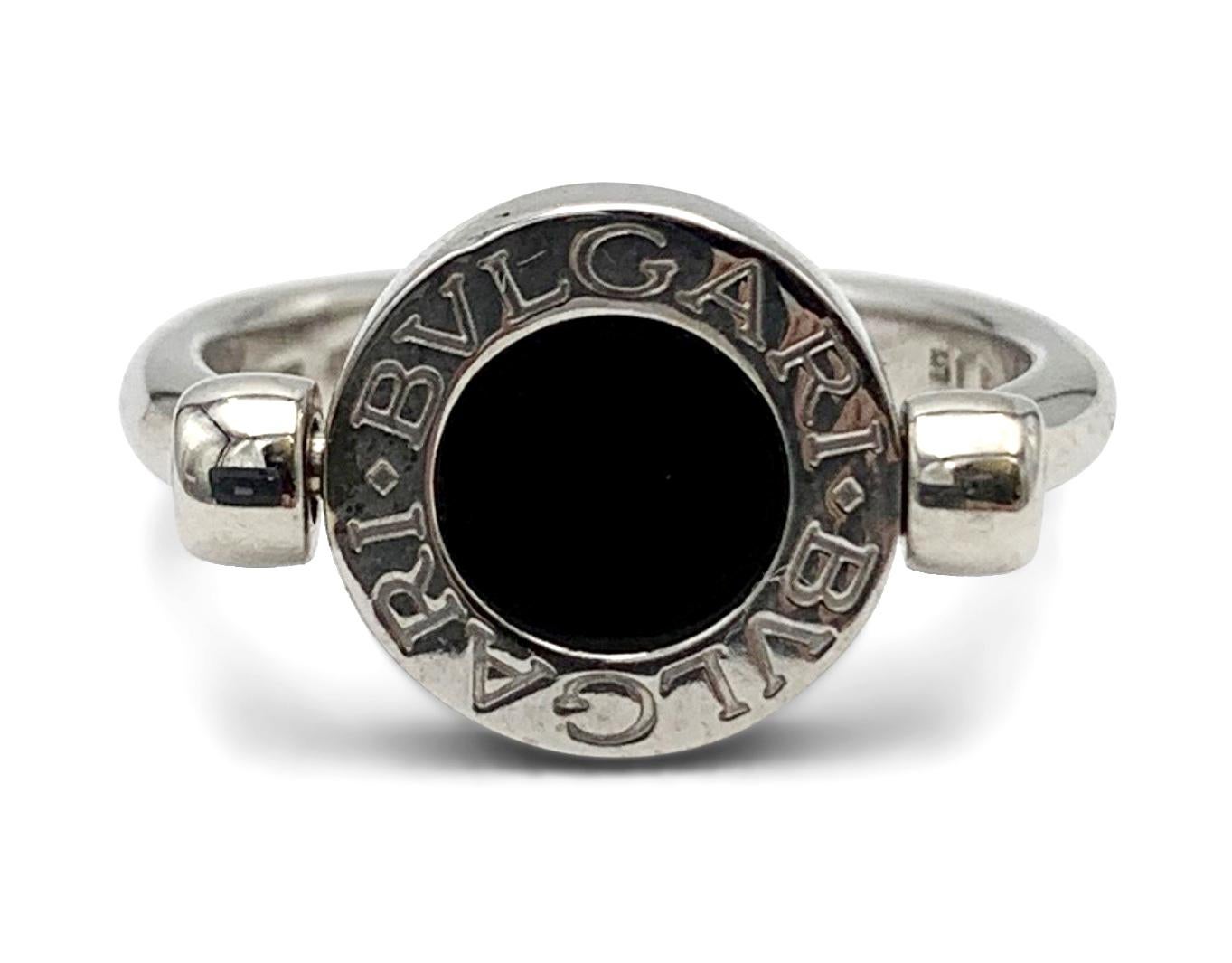 Authentic Bvlgari-Bvlgari flip ring crafted in 18 karat white gold. One side of the ring features pave set high-quality round brilliant cut diamonds weighing an estimated 0.14 carats total weight. The other side is set with an onyx stone. Both sides