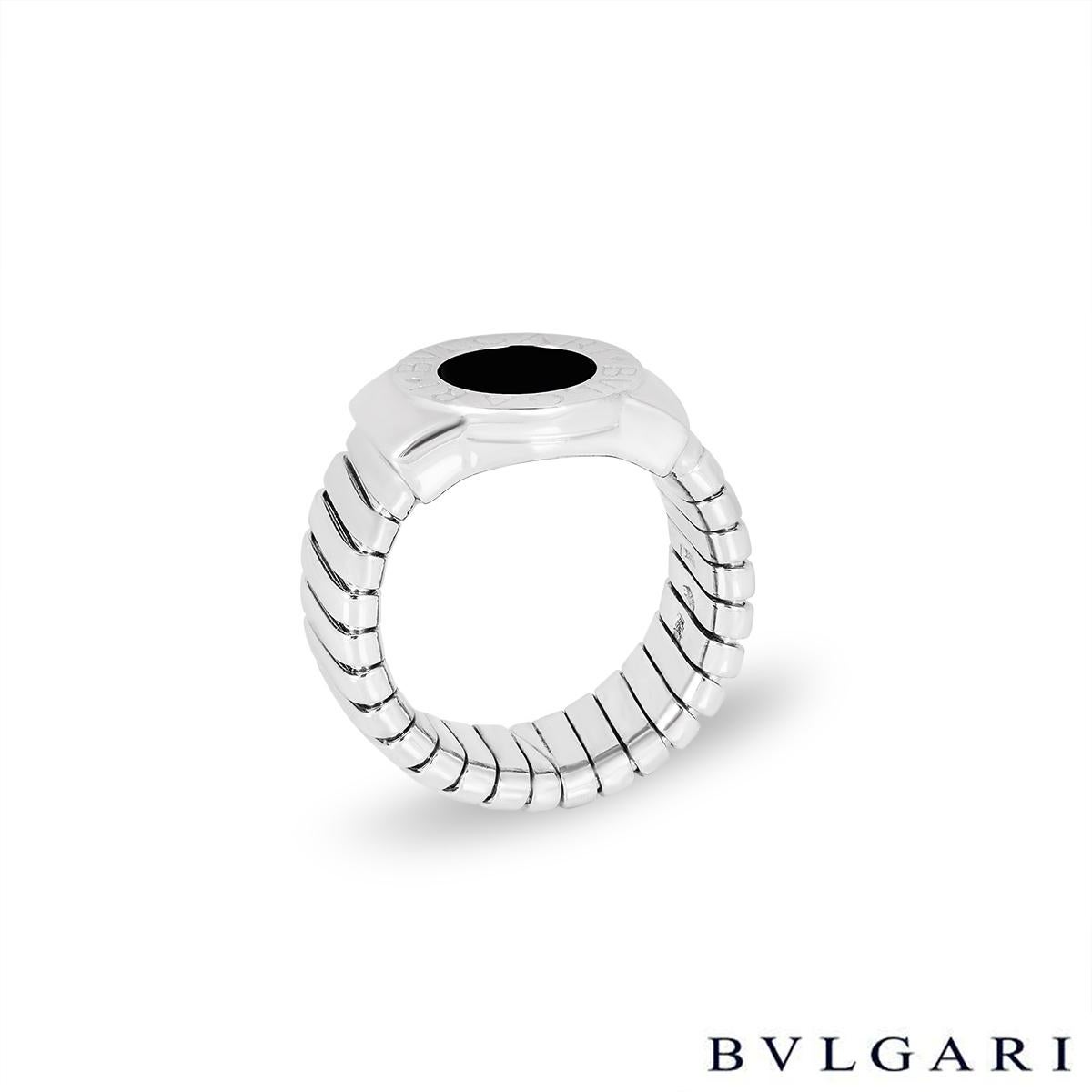 A chic 18k white gold onyx ring by Bvlgari from the Bvlgari Bvlgari collection. The ring is set to the centre with a round onyx inlay in a high polish surround engraved 'Bvlgari Bvlgari'. The Tubogas ring tapers down from 12.8mm to 8.6mm, is a size