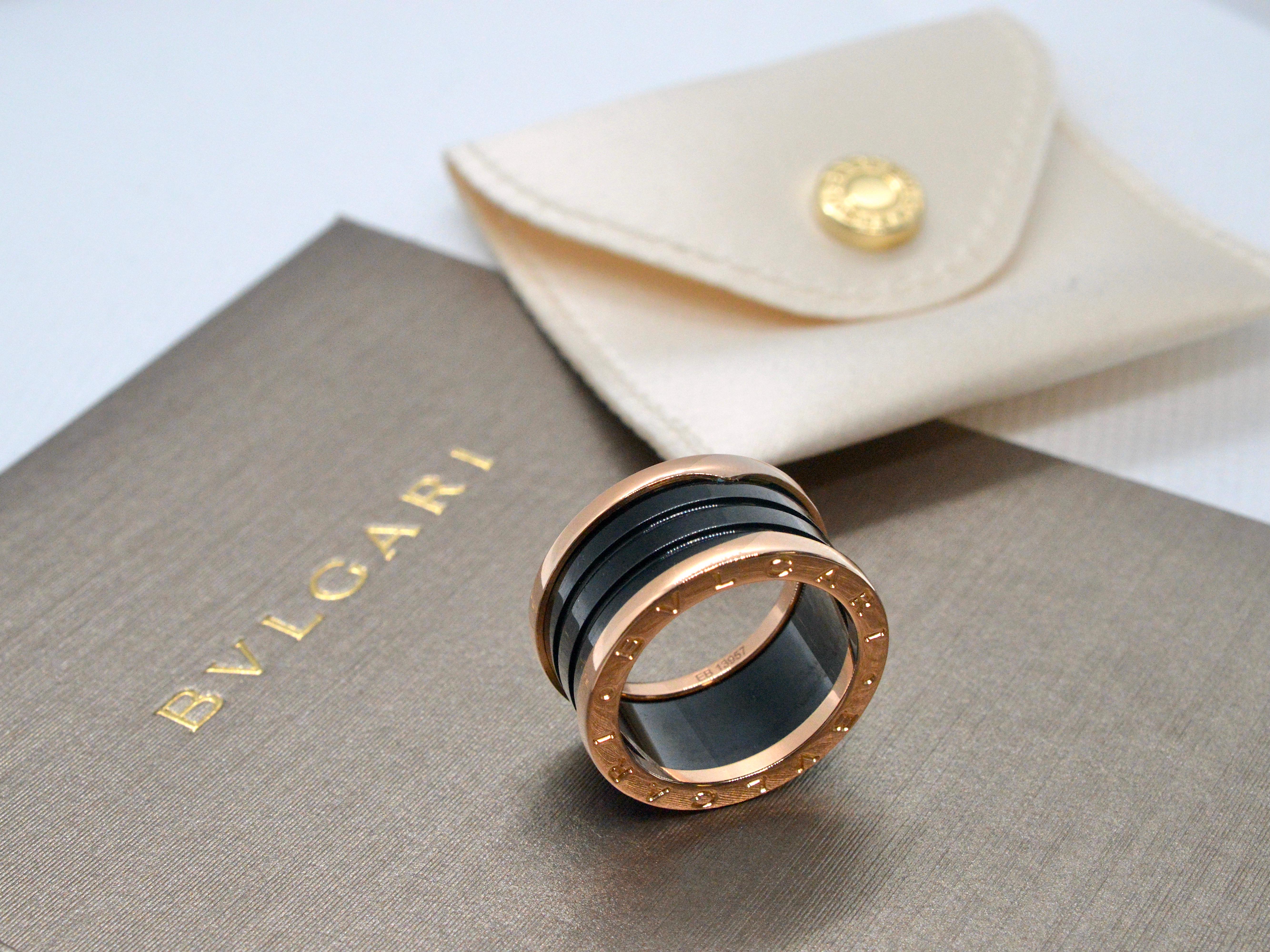 Indulge in the luxurious allure of this BVLGARI B.ZERO1 black ceramic and rose gold ring. With its bold and distinctive design, it's a testament to BVLGARI's craftsmanship and style. This exquisite ring weighs 10.4 grams and is custom-sized to a