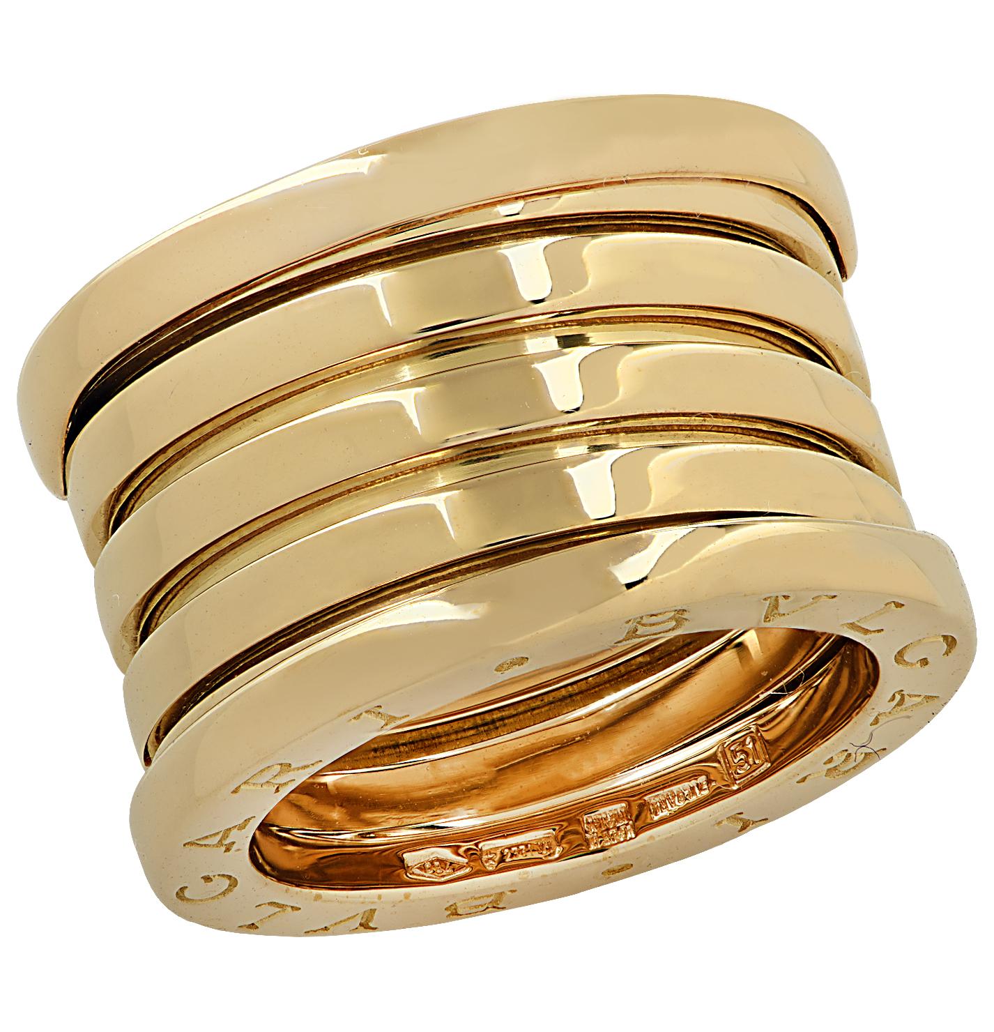 From the House of Bvlgari, this stunning B.Zero 1 XXth Anniversary five-band ring features five bands crafted in 18 karat yellow gold. The outer bands are detailed with the Bvlgari logo. This iconic ring measures .5 of an inch and is a European size