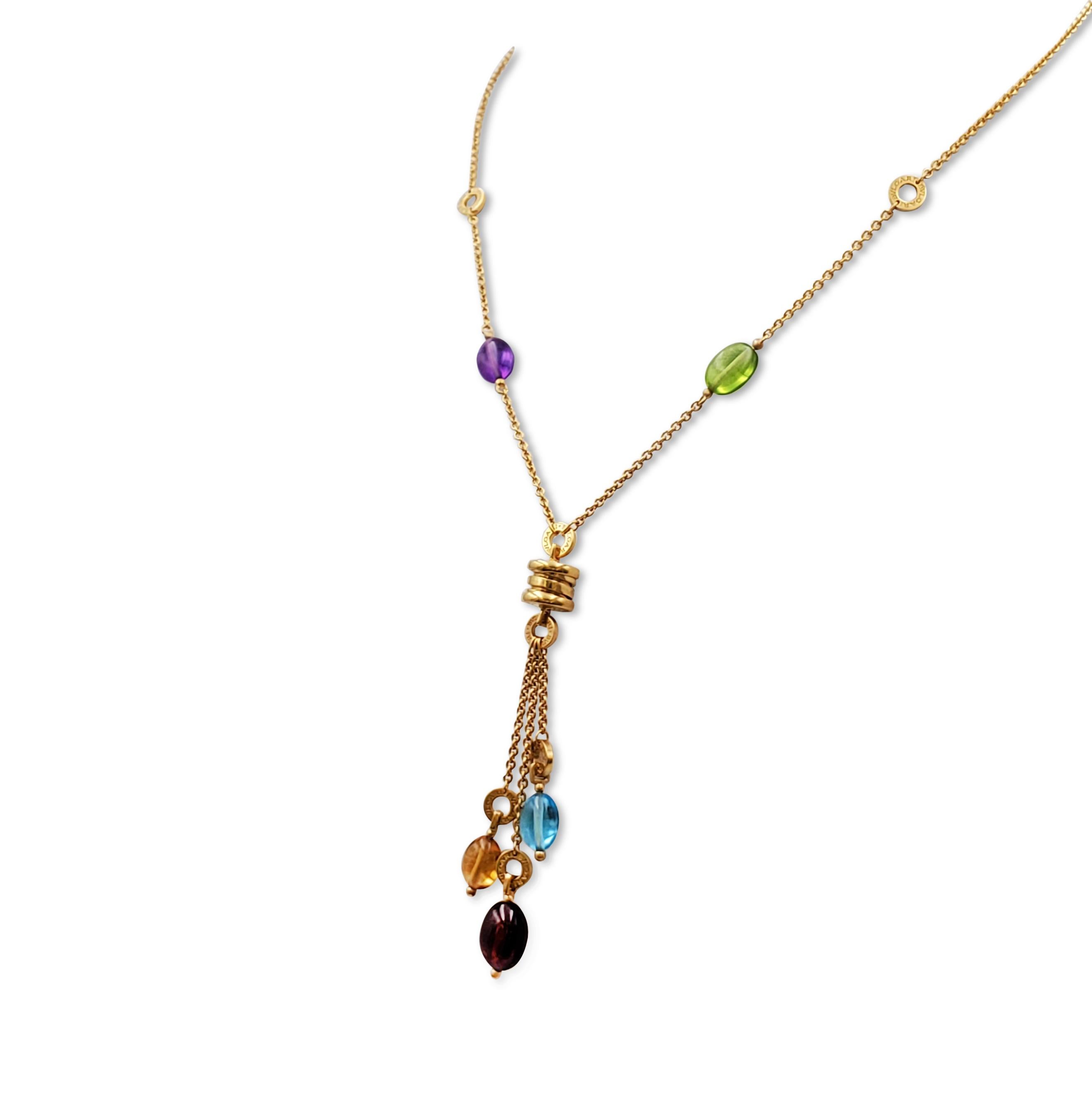 Authentic Bvlgari B.Zero necklace crafted in 18 karat yellow gold and featuring beads of Amethyst, Peridot, Blue Topaz, Garnet, and Citrine.  A 2 1/4 inch pendant is suspended from an adjustable 18 1/2 inch chain.  Signed Bvlgari, 750, Made in