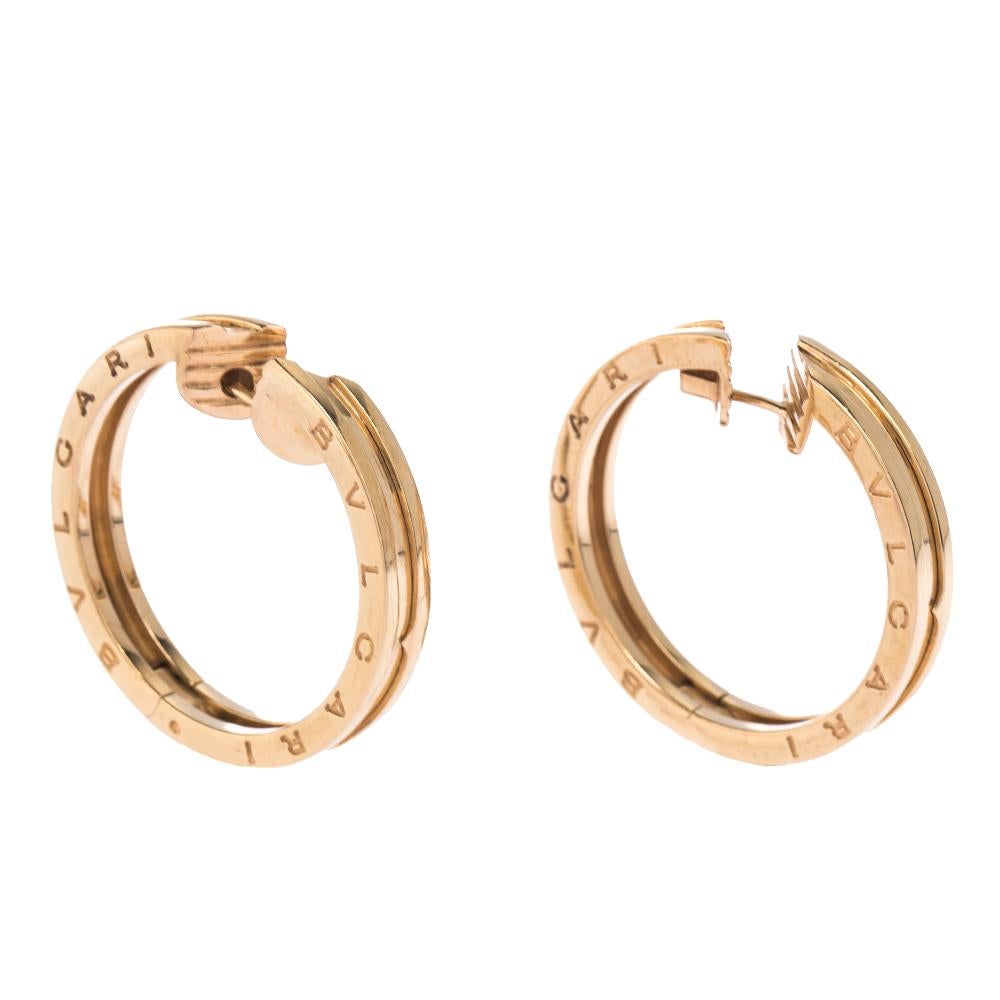This pair of earrings is from Bvlgari's B.Zero1 collection, crafted from 18k rose gold as hoops and beautifully detailed with signature band silhouette. They are complete with the brand's signature engravings. The collection has been designed by