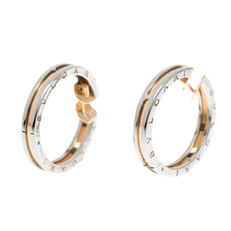 This pair of earrings is from Bvlgari's B.Zero1 collection, crafted from stainless steel as hoops and beautifully detailed with 18k rose gold. They are complete with the brand's signature engravings. The collection has been designed by blending the