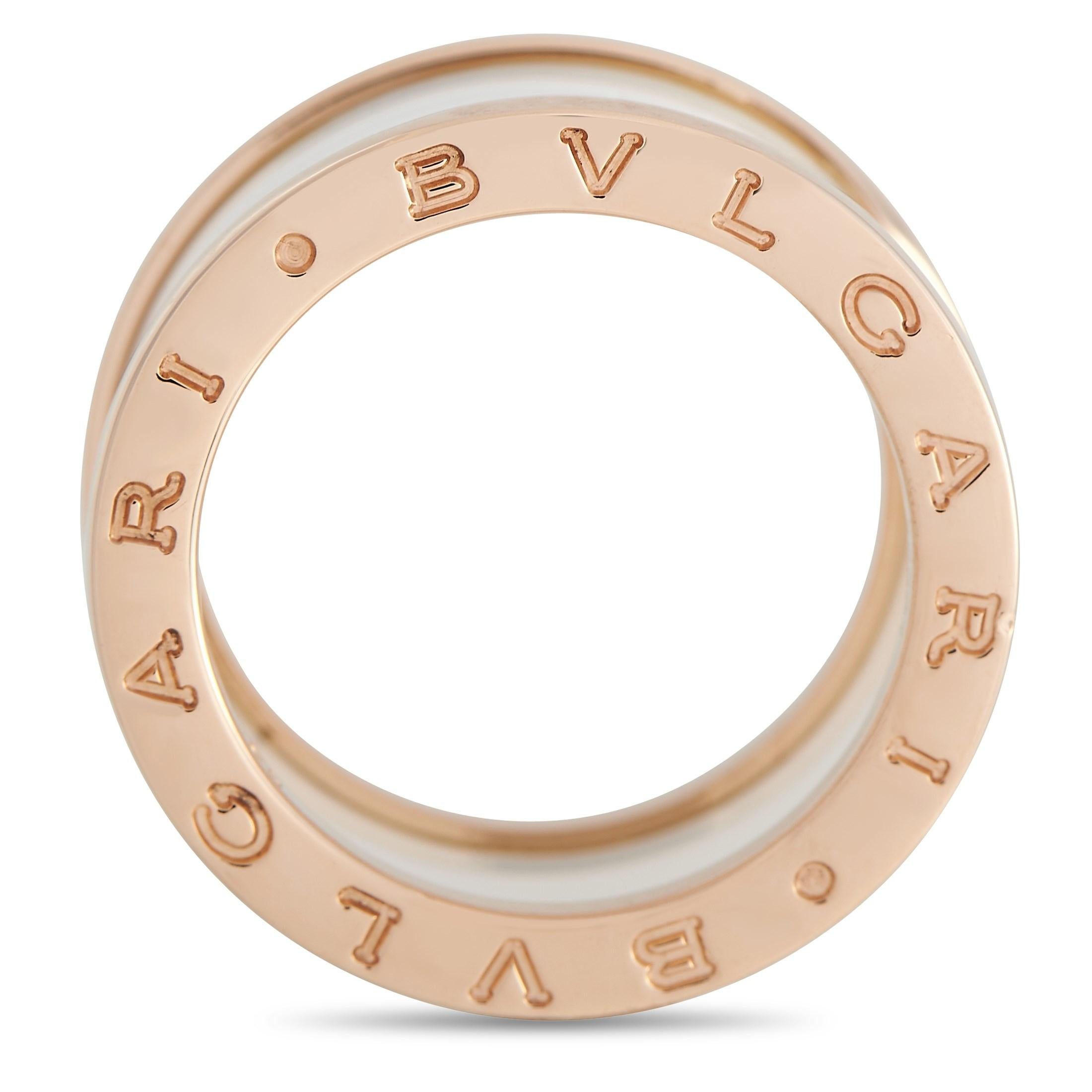 Shimmering 18K rose gold contrasts beautifully against a white ceramic center on this sleek, sophisticated Bvlgari ring from the B.Zero1 collection. This minimalist design measures 11mm wide and includes the luxury brand’s moniker imprinted on each