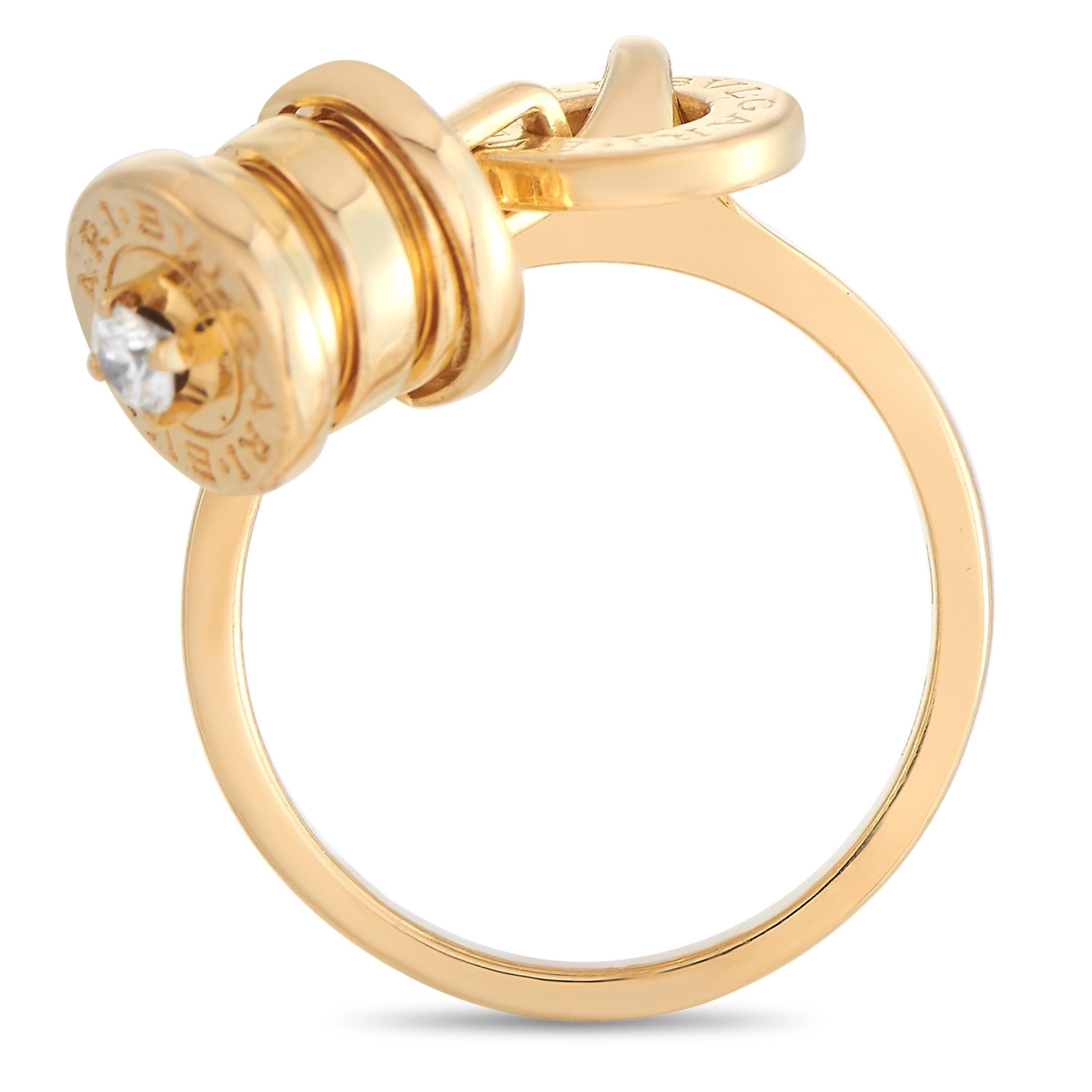 From the legendary jewelry house, Bvlgari, is this one-of-a-kind yellow gold ring with a barrel-like dangling accent. Fashioned in 18K yellow gold, this ring makes a statement with its quirky yet classy dangling charm adorned with a single diamond.
