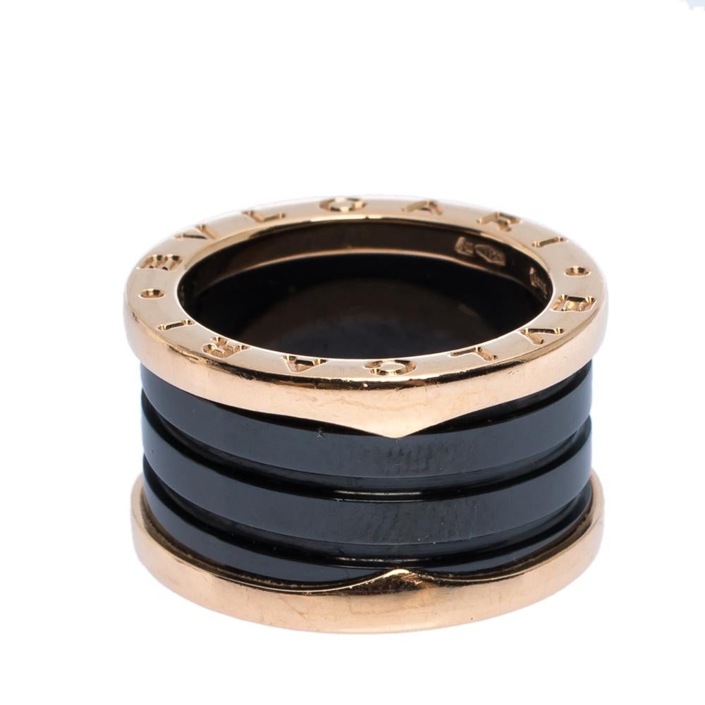 Crafted from 18k rose gold, this Bvlgari B.Zero1 ring features a band silhouette with 4 black ceramic bands stacked on one another. It comes detailed with the brand lettering on it. This ring can be worn as a stand-alone piece or stacked with other