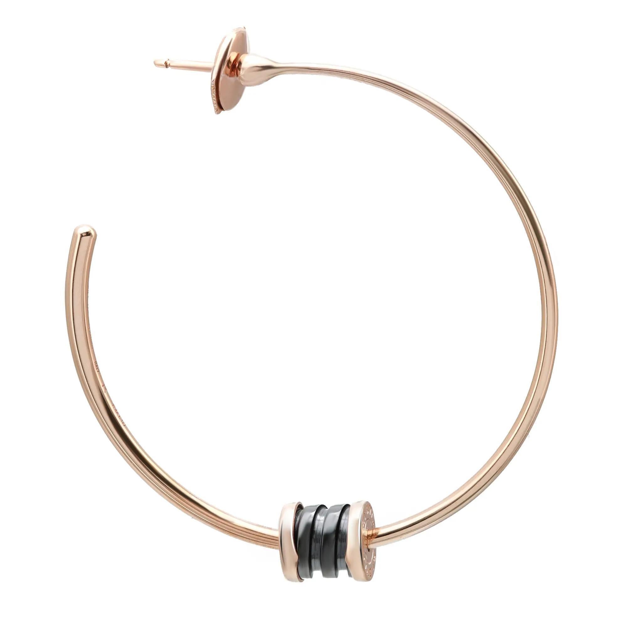 These Bvlgari B.zero1 earrings are a true statement of Bulgari’s creative vision. Fun and beautiful, crafted in lustrous 18K rose gold and ceramic. It features round-shaped rose gold hoop earrings with a spiral circular design in ceramic with rose
