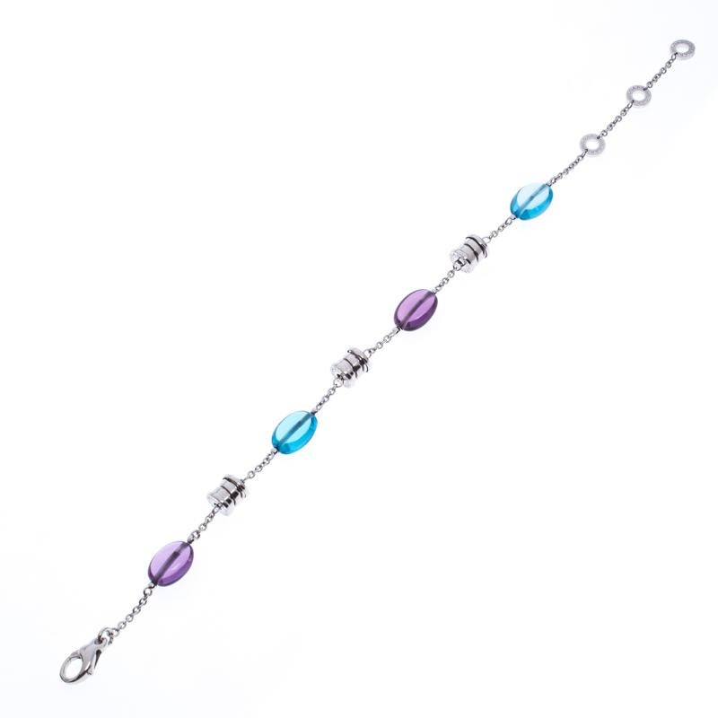 Crafted from an 18k white gold body, this Bvlgari bracelet is a simply elegant accessory to grace your looks. It comes detailed with signature B.Zero 1 spiralled motifs, amethyst and topaz stones as well as signature engraved rings attachments. The