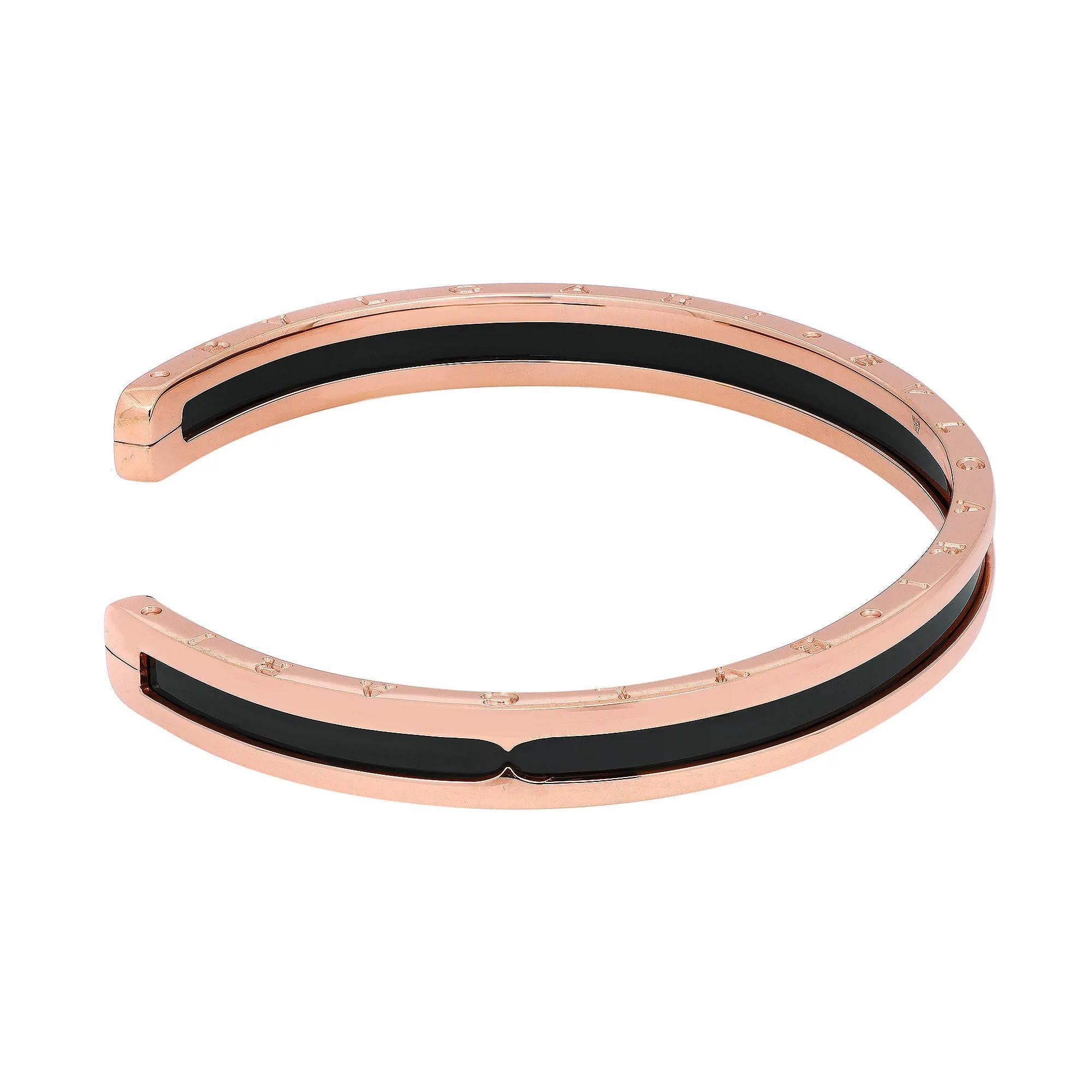 This stunning B.Zero1 open cuff bracelet comes from the house of Bvlgari. Well crafted in 18K rose gold and ceramic. This bracelet features black ceramic in the center with rose gold frame. Bvlgari logo engraving on the edges. Size: Medium. Wrist