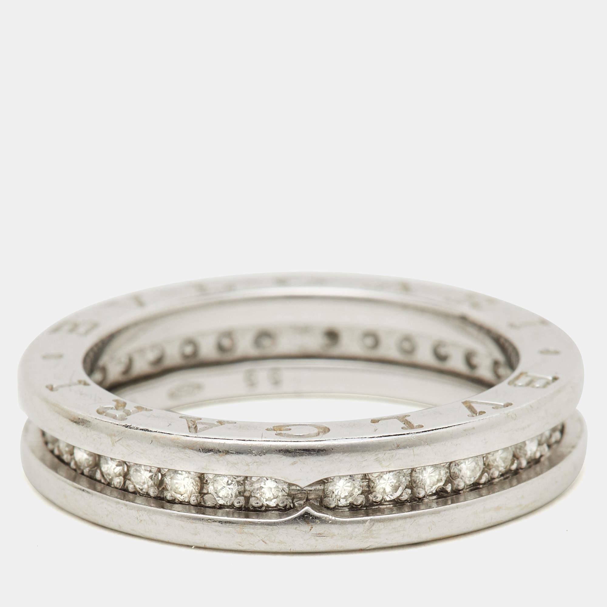 This stunning ring from Bvlgari features notable engravings. Added with diamonds in a design that merges modernity with eternity, this ring is crafted from 18k white gold and shines beautifully.

Includes
Brand Case, Authenticity Card