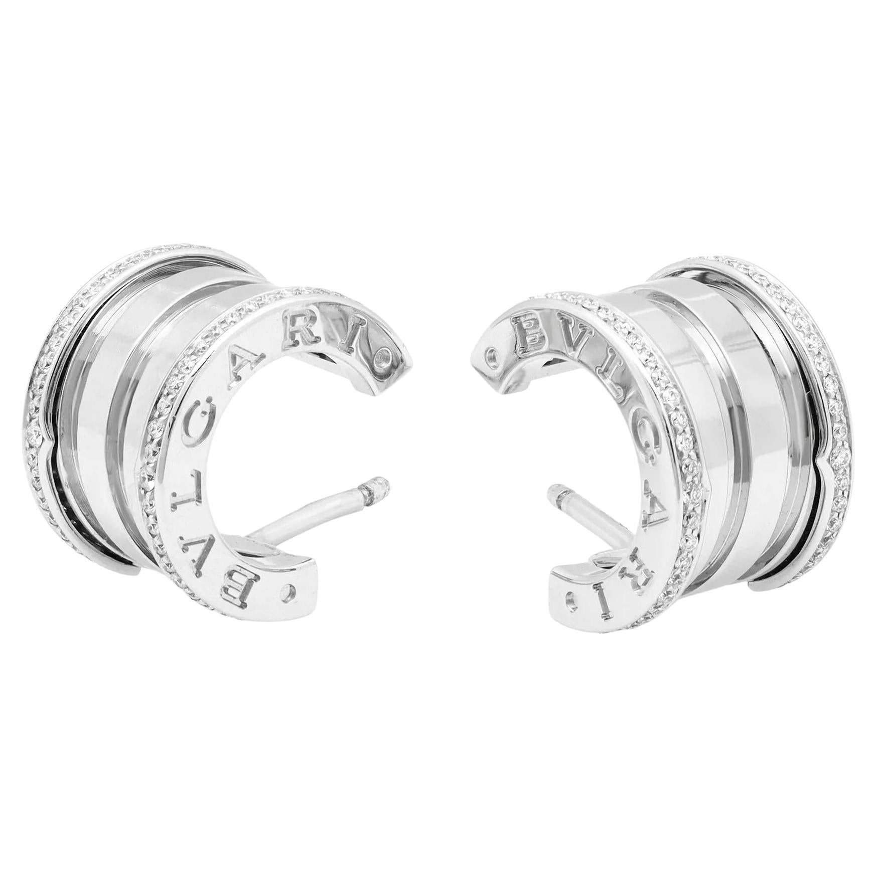 These dazzling diamond huggie earrings from the house of Bvlgari are a perfect addition to your jewelry collection. Crafted in fine 18K white gold, it features pave set round brilliant cut diamonds set on the outer rim of the earrings with engraved