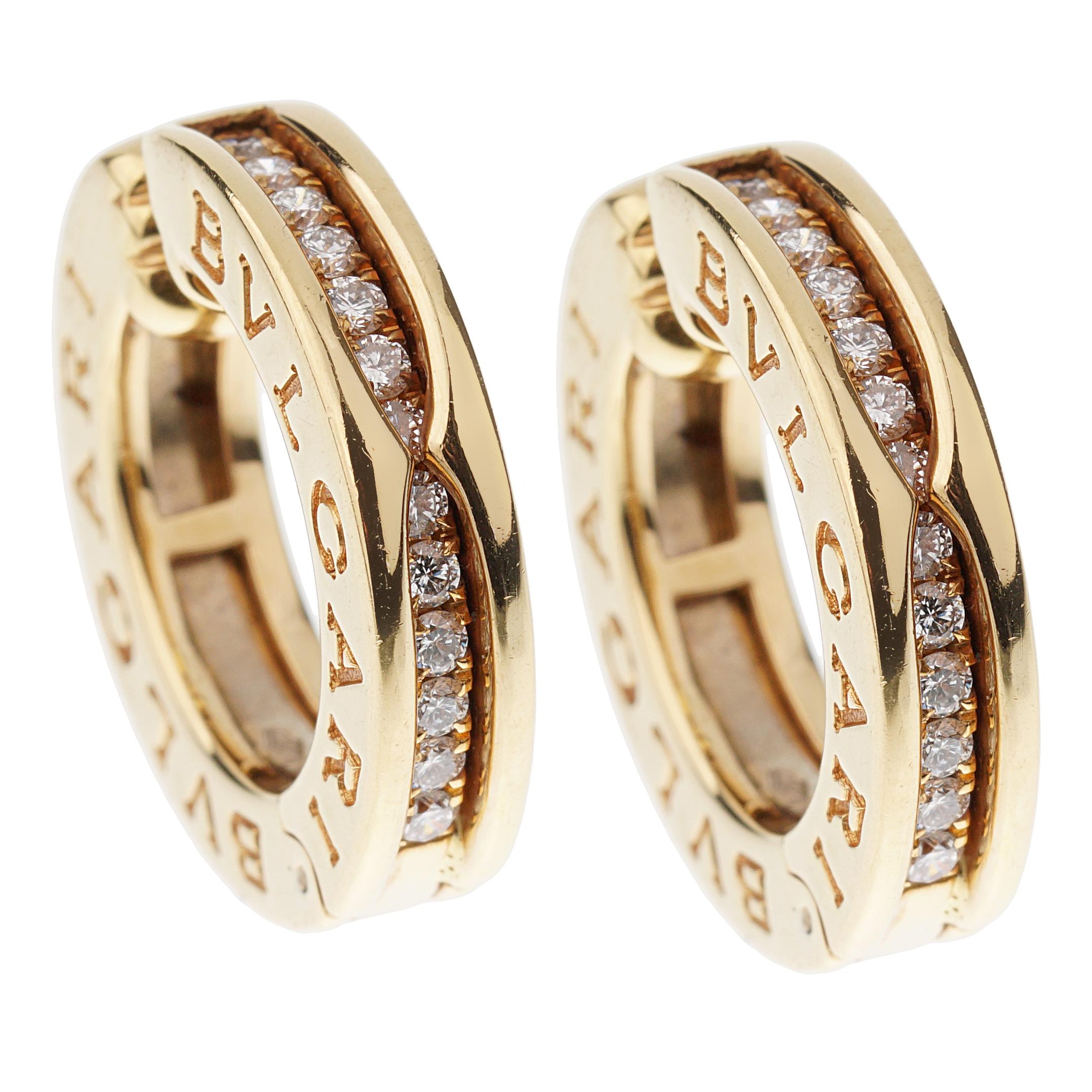 A chic set of Bvlgari Bzero1 earrings showcasing a row of 26 round brilliant cut diamonds VS clarity F-G Color set in 18 yellow gold. The earrings have a diameter of .74