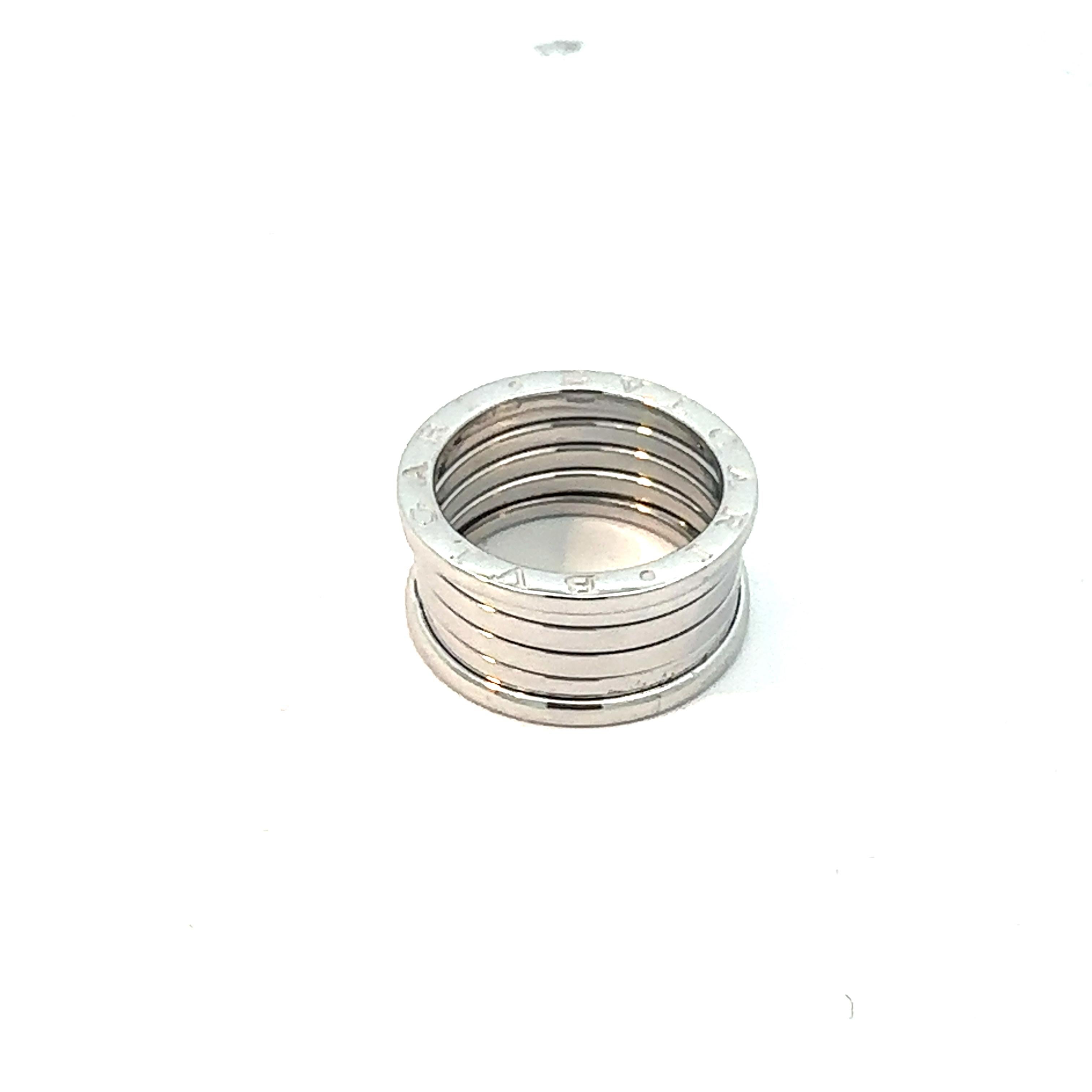 The BVLGARI B.Zero1 White Gold 20th Anniversary 5 Bands Ring is a luxurious tribute to two decades of iconic design. Crafted from exquisite white gold, the ring features the hallmark spiral design inspired by Rome's Colosseum, symbolizing eternity