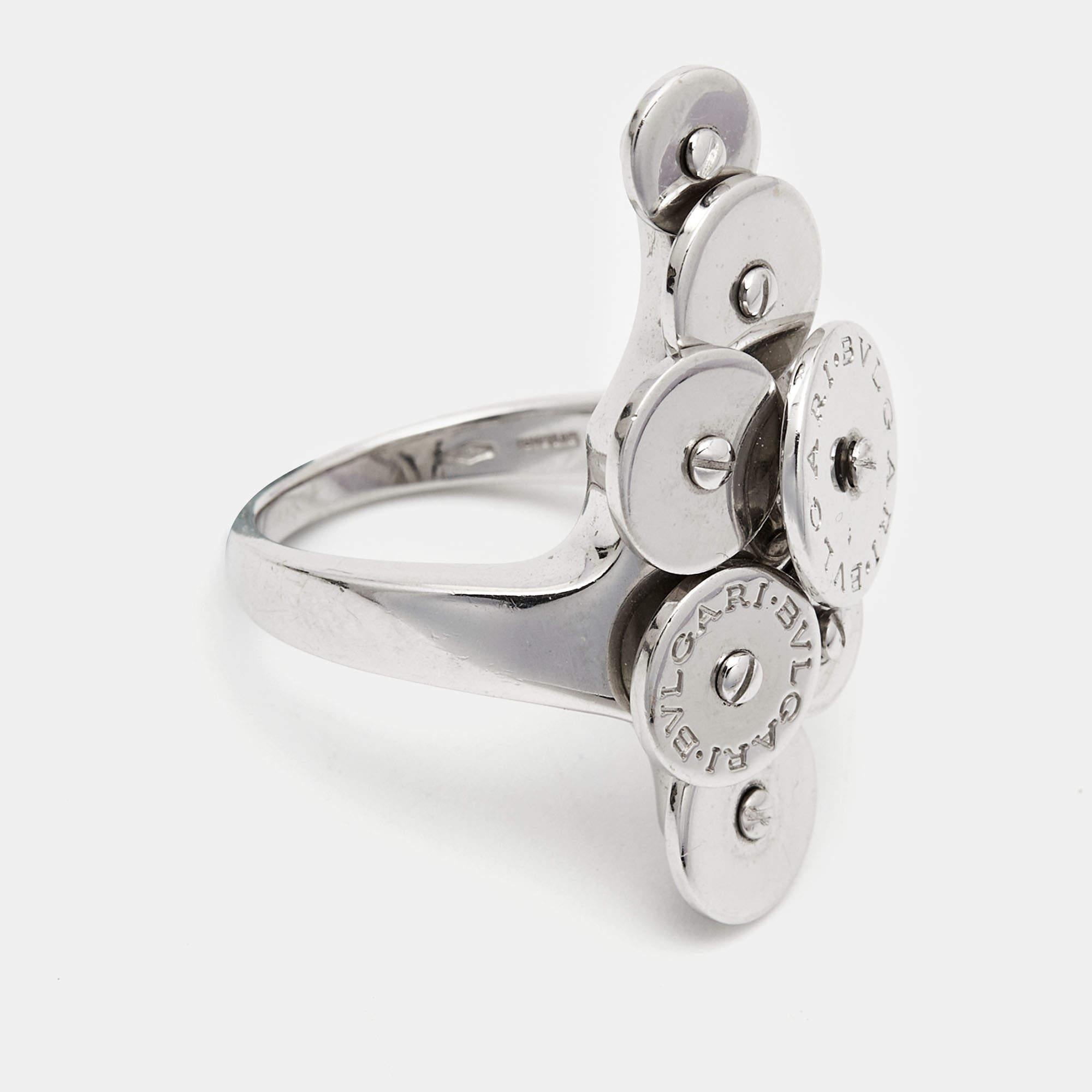 Bvlgari brings to you this wonderful Cicladi ring to adorn you with sheer elegance and luxury. Made out of 18K white gold, this piece features 7 round plate-like details that rotate, and out of which two are engraved with the brand signature. High