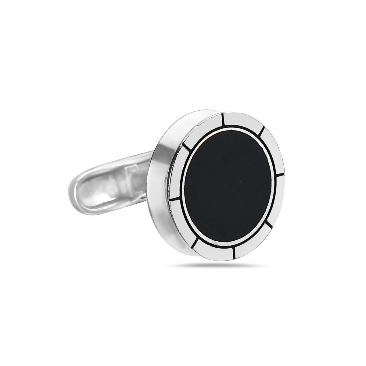 These BVLGARI cufflinks are crafted from sterling silver with a high polished finish, it features the round disc with BVLGARI engraved on the bezel with black onyx in the center. Signed BVLGARI.