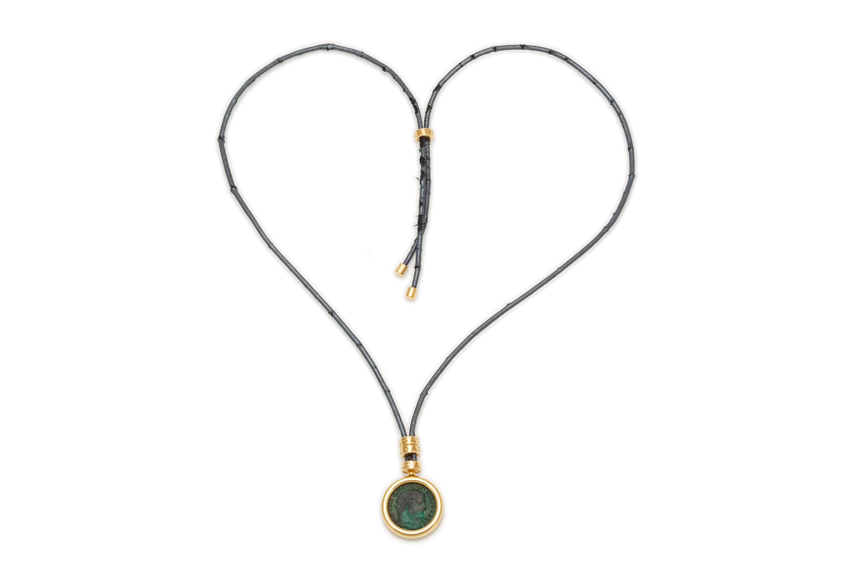 Necklace with a coin finely crafted in 18k gold on a cord. Signed by Bvlgari. Circa 1970's.