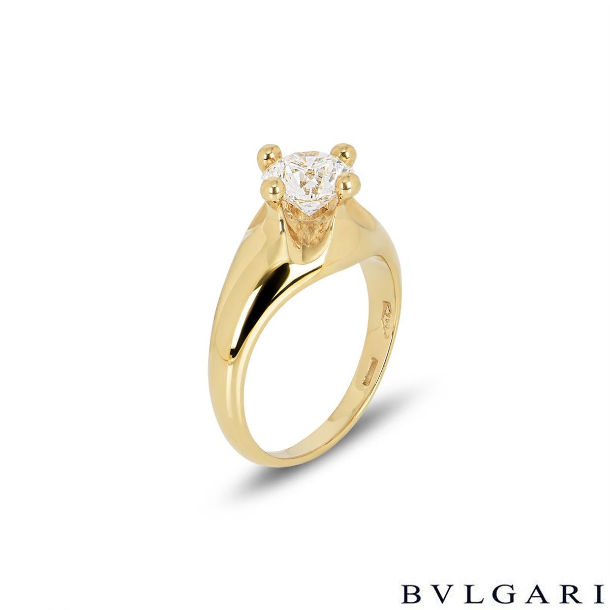 A stunning 18k yellow gold Bvlgari diamond engagement ring. The ring is set to the centre with a 1.00ct round brilliant cut diamond in a raised four claw compass setting, F in colour and VS1 in clarity. The tapered 8mm ring is currently a size UK H½