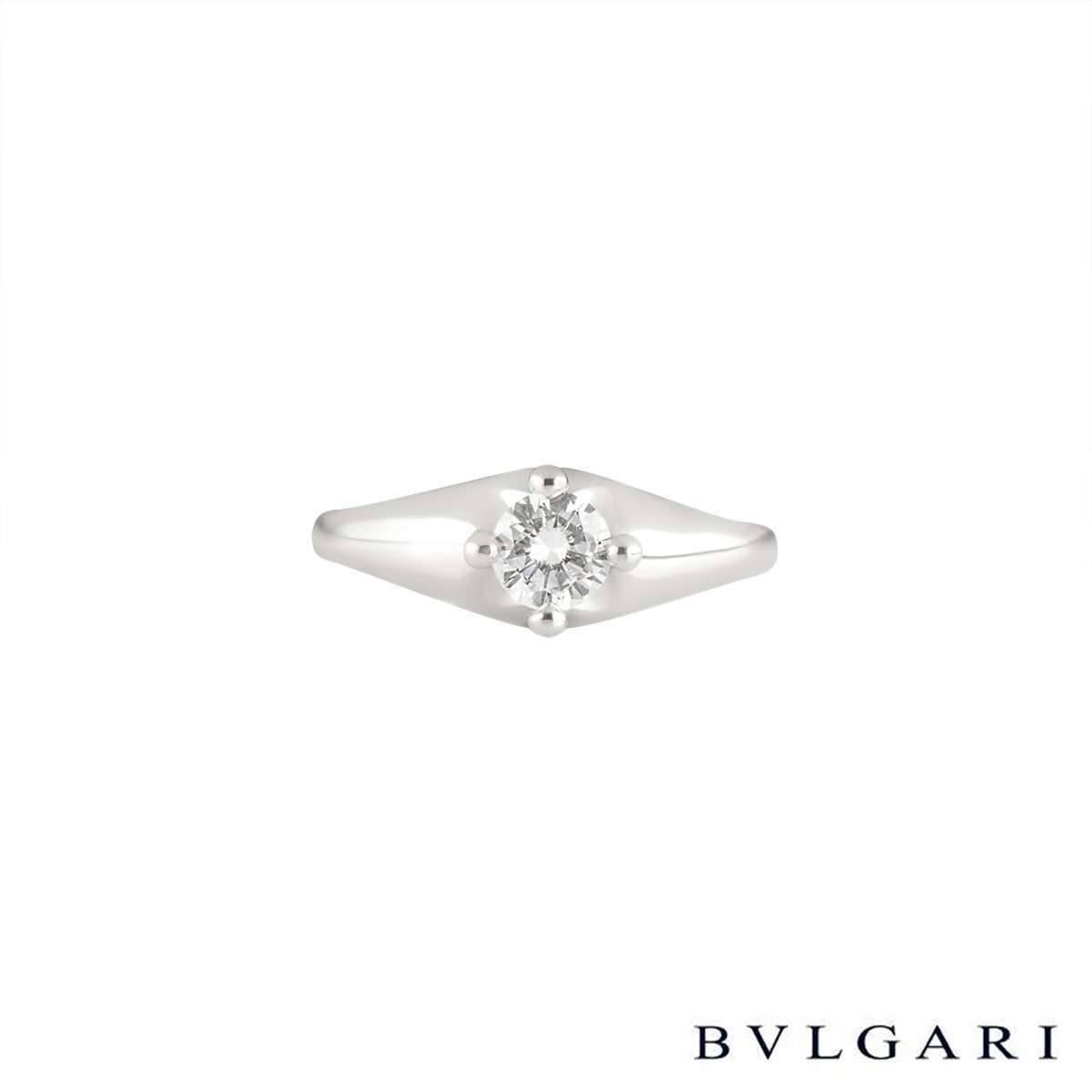 A sparkly platinum Bvlgari diamond single solitaire from the Corona collection. The ring is set to the centre with approximately a 0.30ct round brilliant cut diamond in a raised four claw compass setting, F colour and VS1 clarity. The tapered 6mm