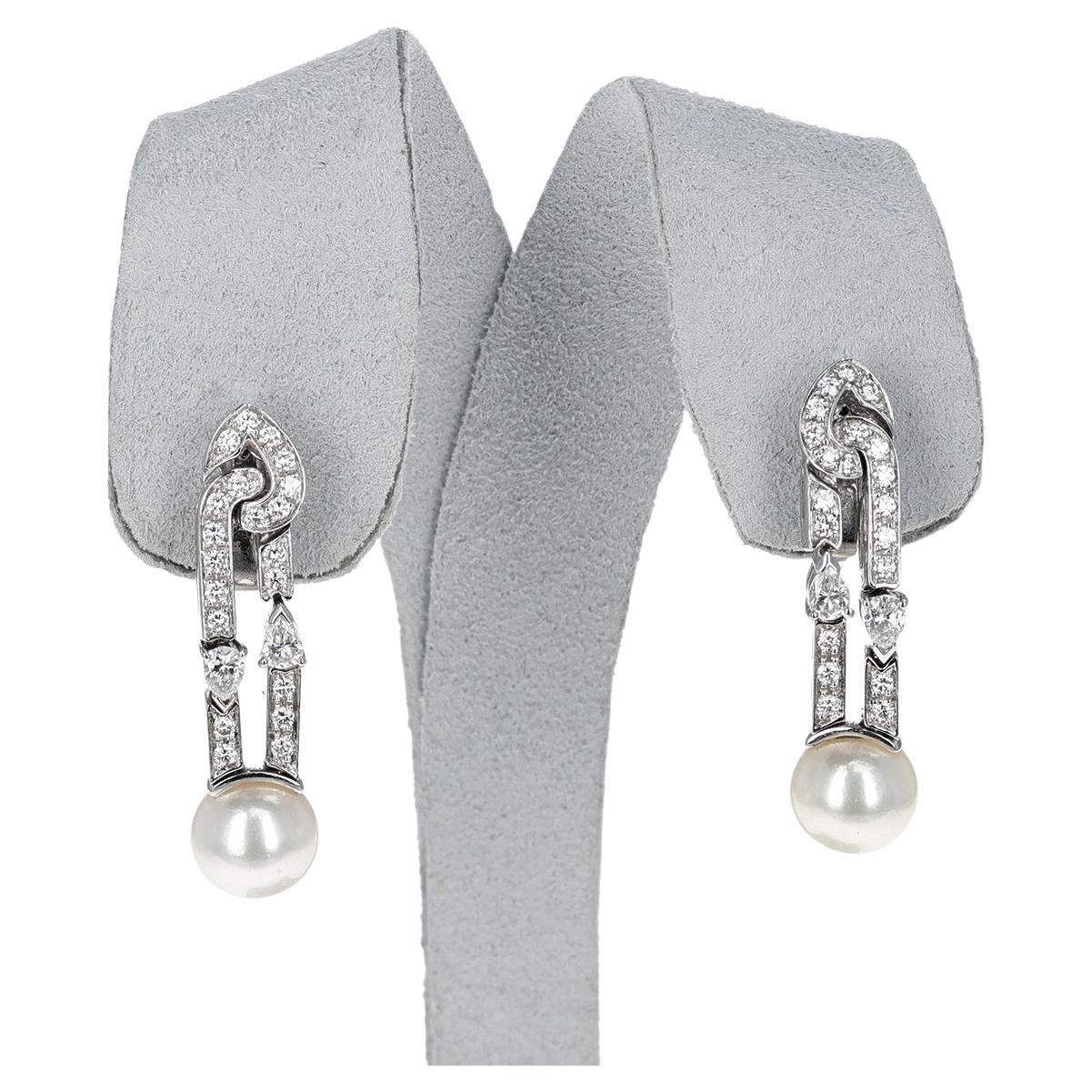 A pair of Bvlgari Cultured Pearl Earrings with Round and Pear Shape Diamonds on top made in 18 Karat White Gold. The total weight of the diamonds is appx. 0.85 carats. The total weight of the earring is 12.58 grams. Length is appx. 3.5CM. Original