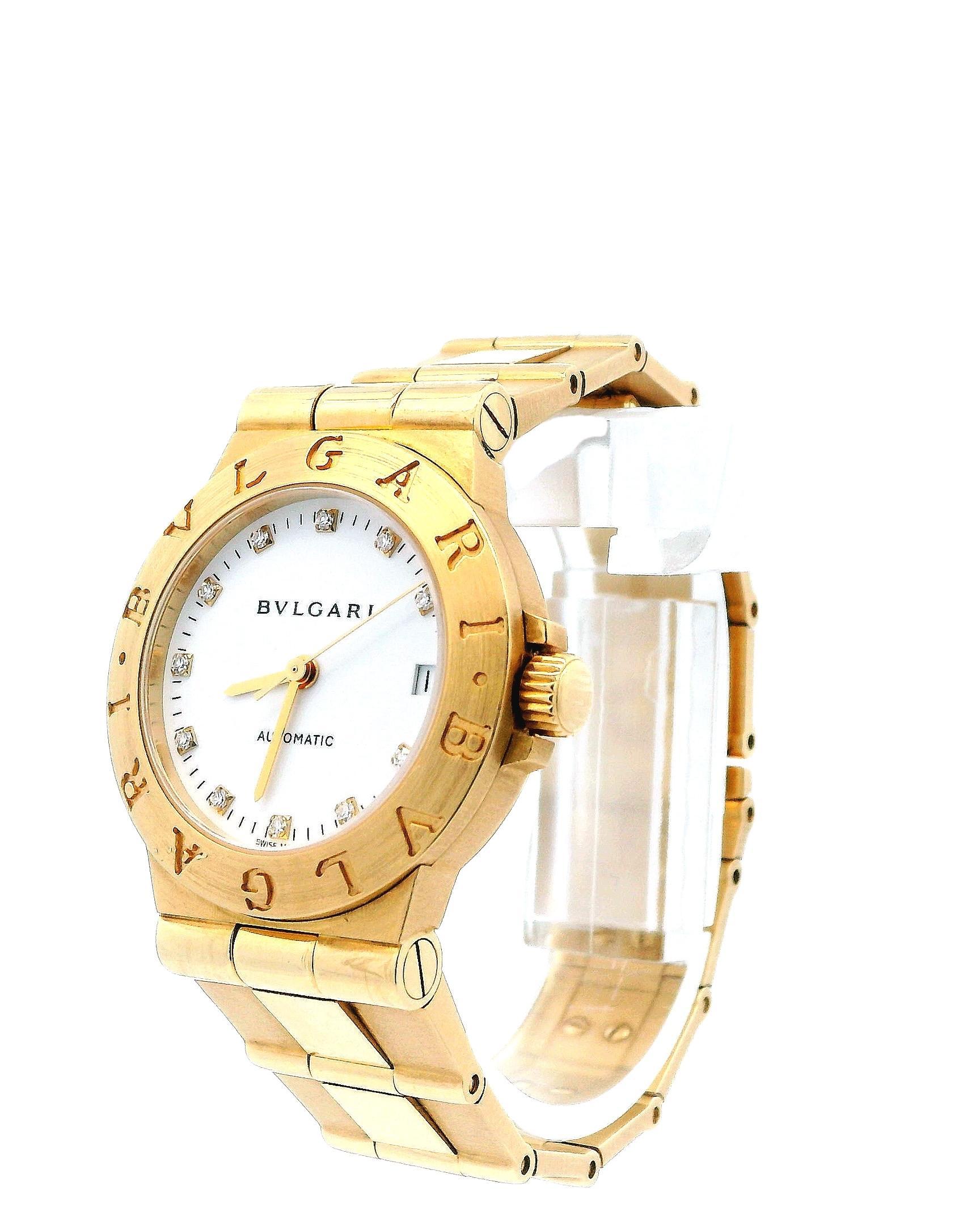 Bvlgari Diagono LCV29G Midsize Ladies' Watch. This timepiece features a 29.5mm 18K yellow gold case and an 18K yellow gold bezel. It has a white dial with gold hands and original factory-set diamond hour markers. The date display is located at the 3