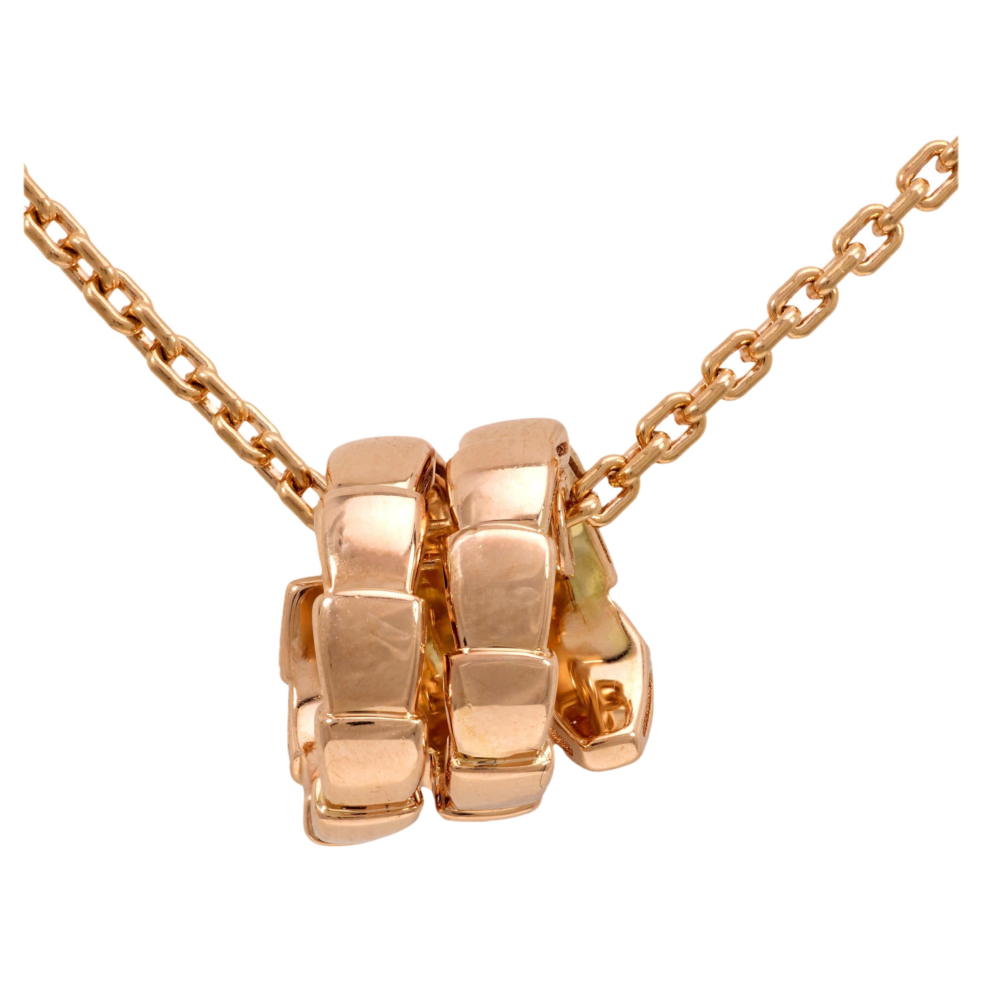 This modern Bvlgari Serpenti Viper necklace coils in sleek 18k rose gold, adorned with seven icy D-E color diamonds for a subtle touch of brilliance. Embodying the brand’s signature serpent motif, this elegantly sculpted piece is signed and
