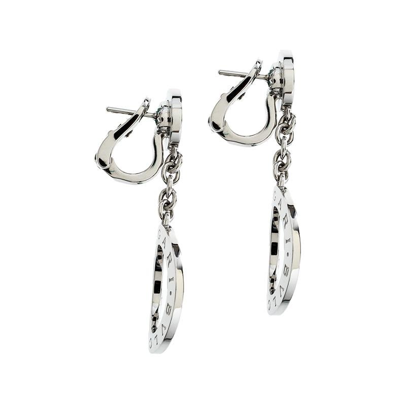 Coming from the house of Bvlgari, these earrings feature a drop style cast in 18k white gold. It comes with a diamond embedded top and weight about 18.30 grams. It features a 'Bvlgari' etched circular drop and can be styled easily with any off-duty