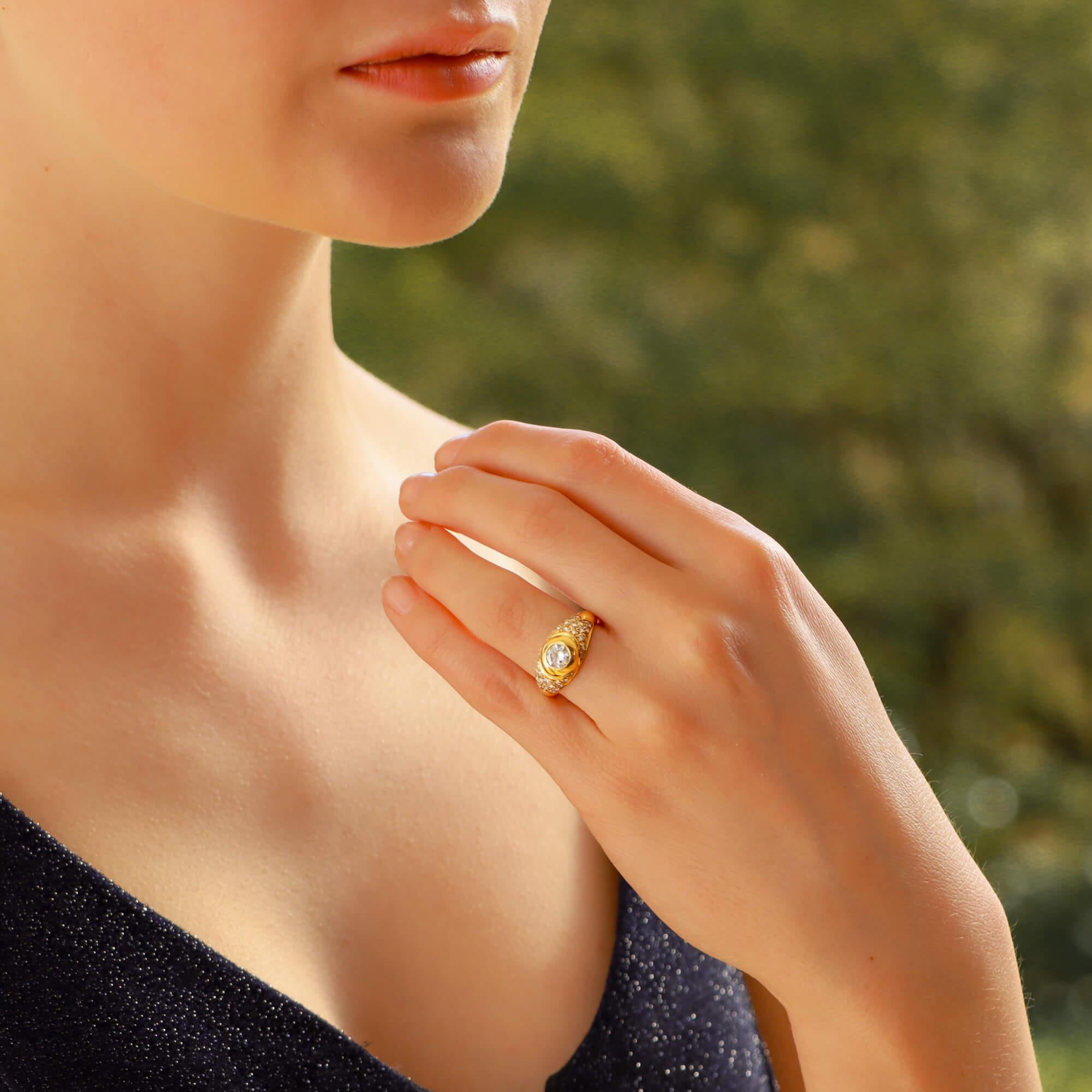 A beautiful vintage Bvlgari ring set in 18k yellow gold. The ring features a round brilliant cut diamond to the centre weighing approximately 0.40ct; this is then accented by thirty-two round brilliant cut pave set diamonds.

This ring is a classic