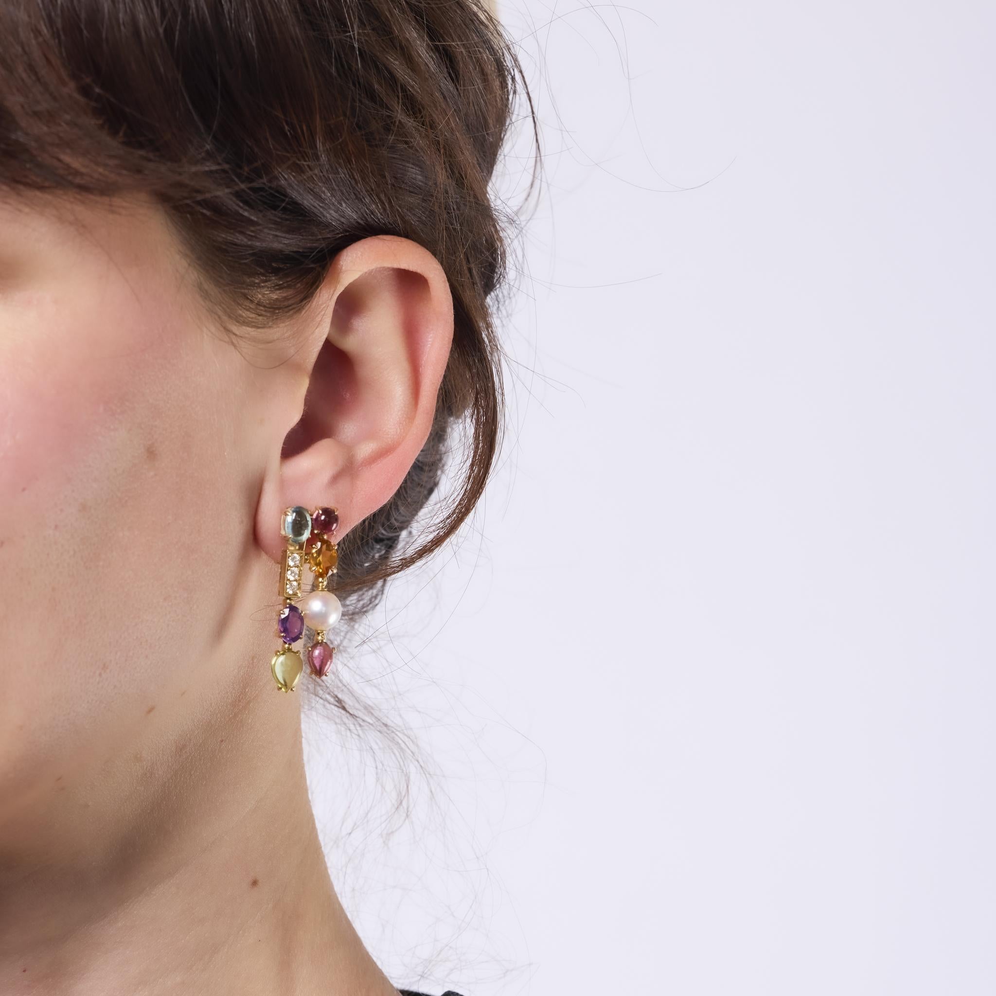 These vibrant Bvlgari Allegra earrings dazzle with luminous pearls, sparkling diamonds, and an array of colorful gemstones including amethyst, peridot, citrine, and topaz. Set in 18k yellow gold, their bold and joyful design radiates signature