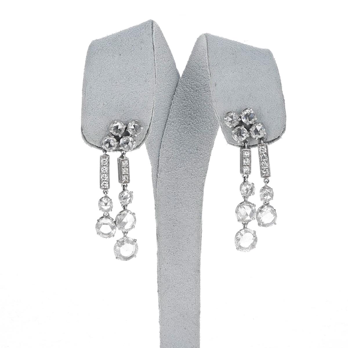 A pair of BVLGARI Diamond Rose Cut Dangling Earrings made in 18k.white gold. The diamond rose cuts weigh 6.38 carats and the round brilliant cuts weigh 0.39 carats. The length is 1.60