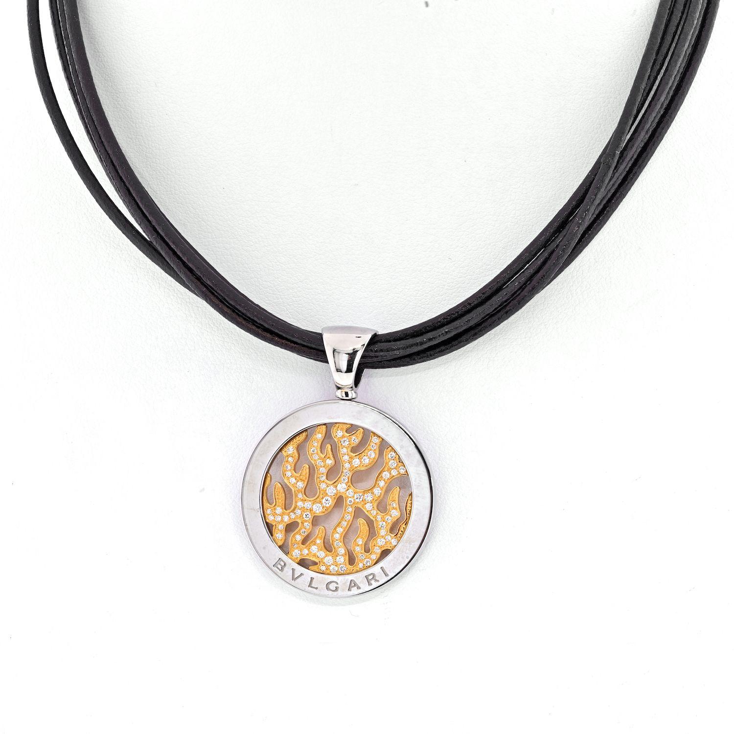 Bvlgari Diamond Tondo Fire Flame On A Black Cord Necklace. 18K Yellow gold, stainless steel. 
Cord: 16 inches. 
Pendant: diamonds 0.65cts. approx. 
Medallion width: 1 inch