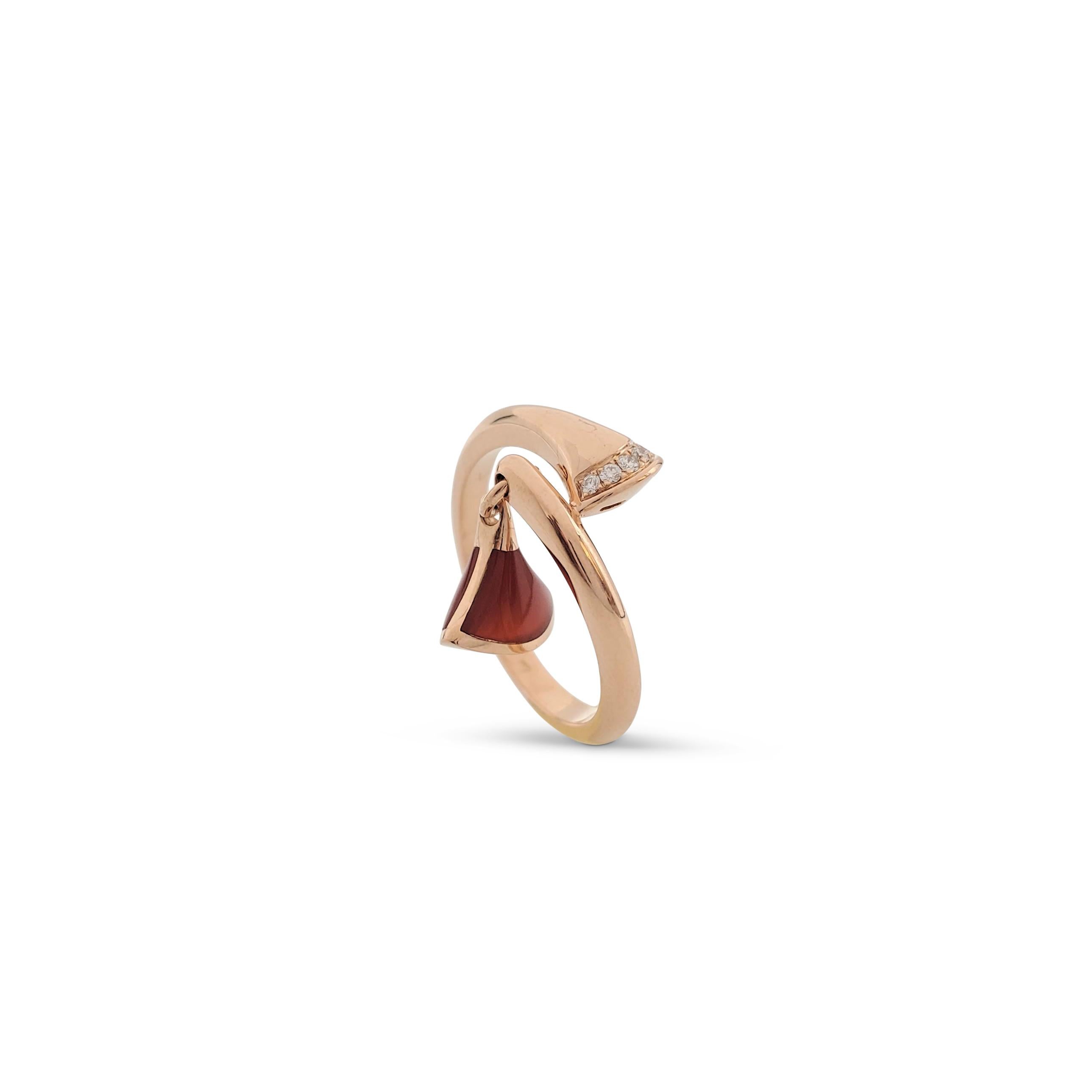 Authentic Bvlgari ring from the 'Divas' Dream' collection is crafted in 18 karat rose gold. The ring is set with an estimated 0.05 carats of round brilliant cut diamonds and features a fan-shaped carnelian charm. Signed Bvlgari, Au750, Made in
