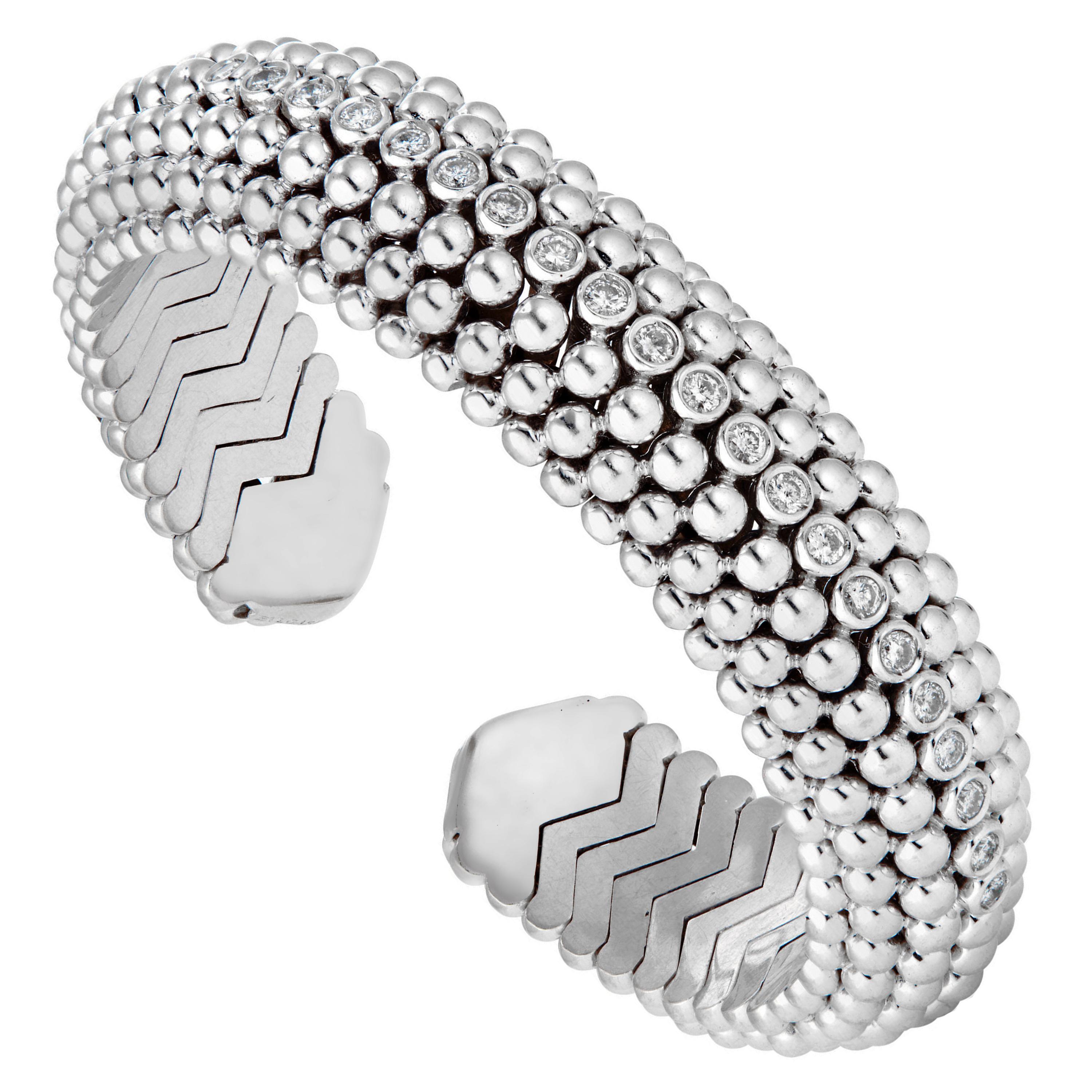 A vintage Bvlgari bracelet dating the Dolce Vita period of 1950s Rome, this bracelet is designed as a beaded mesh atop hand formed curved tubogas links in 18k white gold. The center row is adorned with the finest original Bvlgari round brilliant cut