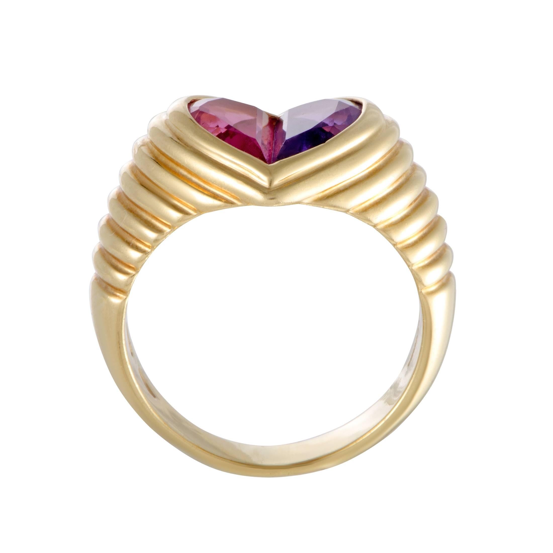 This beautiful ring by Bulgari is elegantly crafted in shimmering 18K yellow gold. The gorgeous ring's design features a heart adorned in a captivating pink tourmaline and a mesmerizing purple amethyst that add a glamorous appeal to the attractive