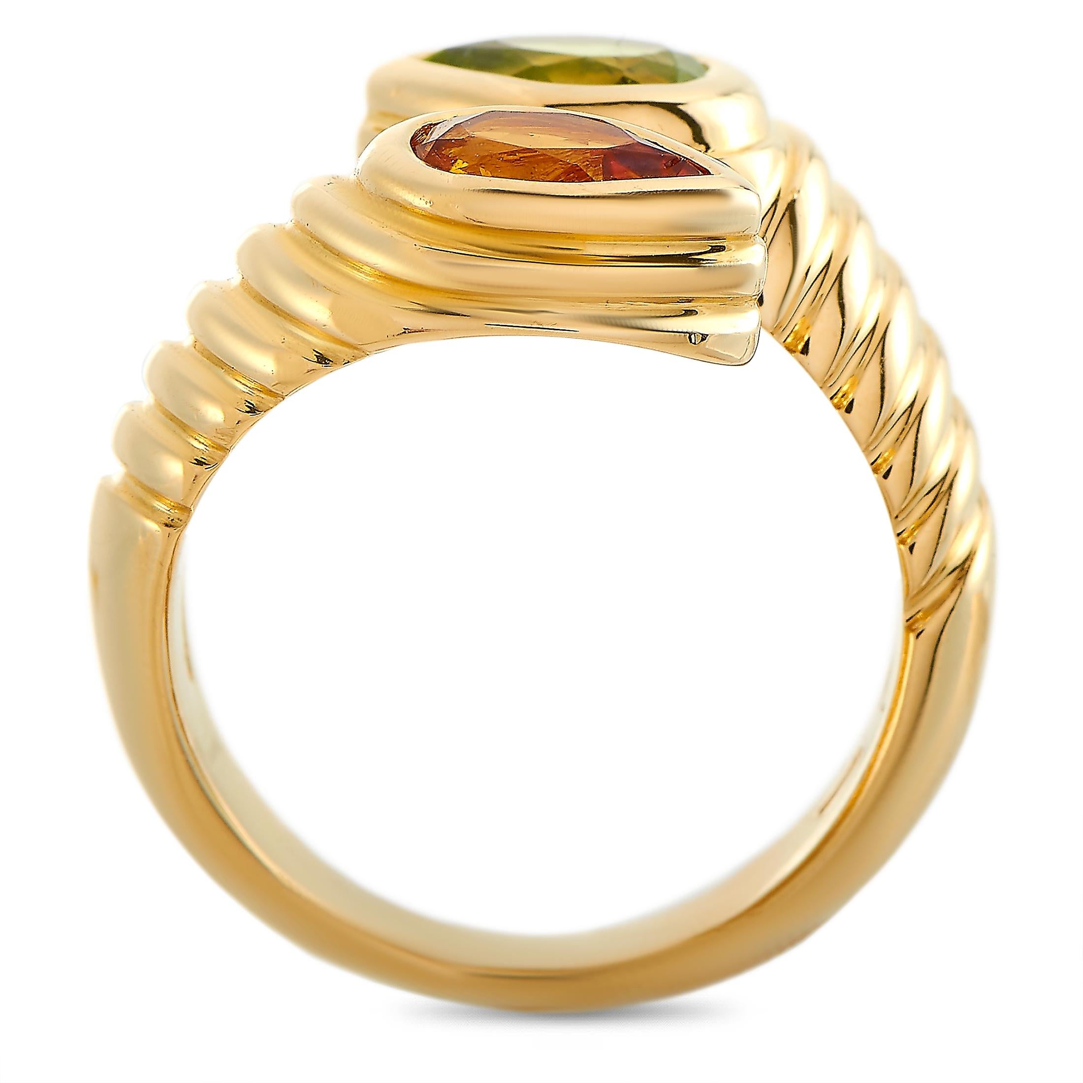 The Bvlgari “Doppio” ring is made of 18K yellow gold and embellished with a citrine and a peridot. The ring weighs 10.9 grams and boasts band thickness of 3 mm and top height of 3 mm, while top dimensions measure 15 by 10 mm.
 
 This jewelry piece