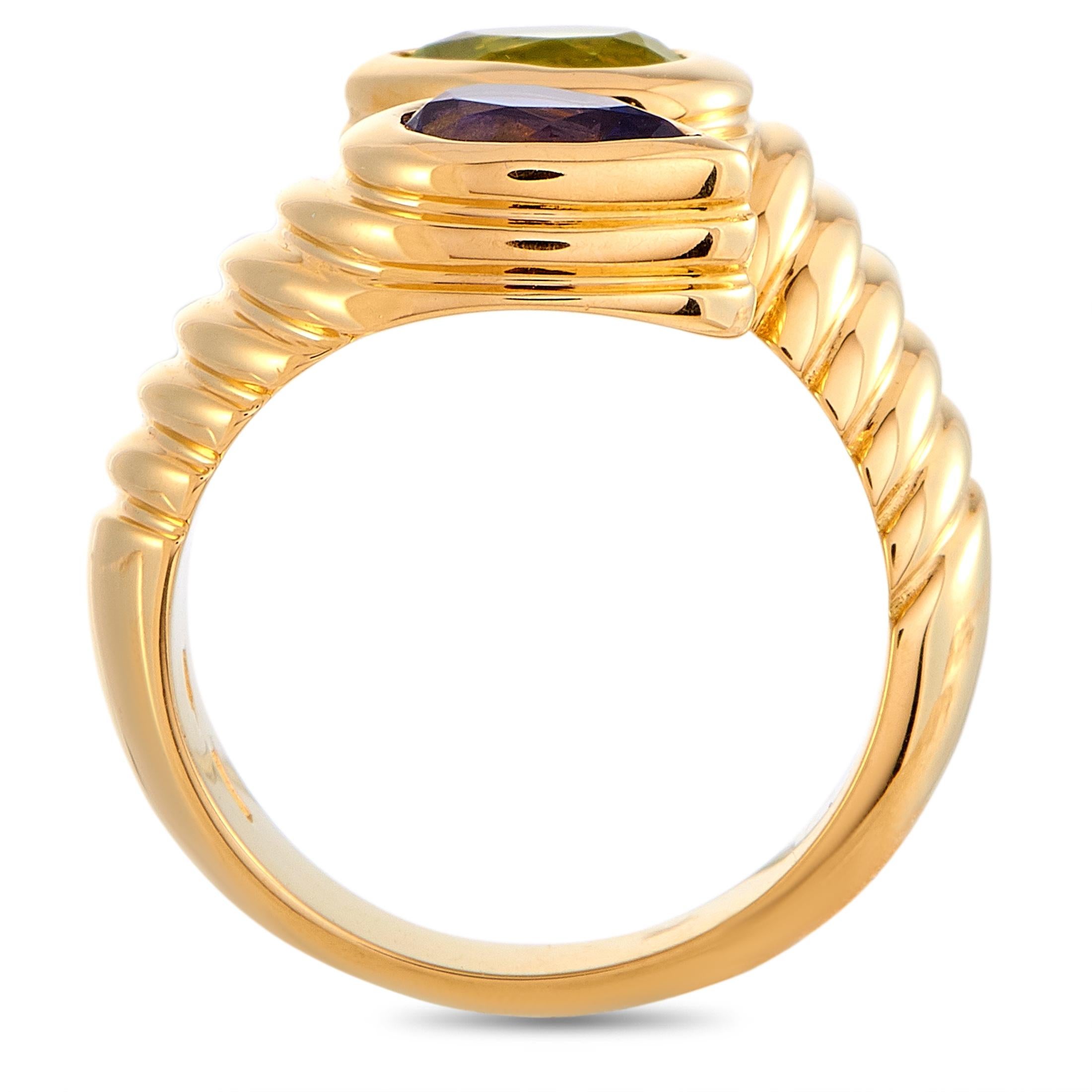 The Bvlgari “Doppio” ring is made of 18K yellow gold and embellished with an iolite and a peridot. The ring weighs 10.4 grams and boasts band thickness of 5 mm and top height of 6 mm, while top dimensions measure 15 by 10 mm.
Ring Size: