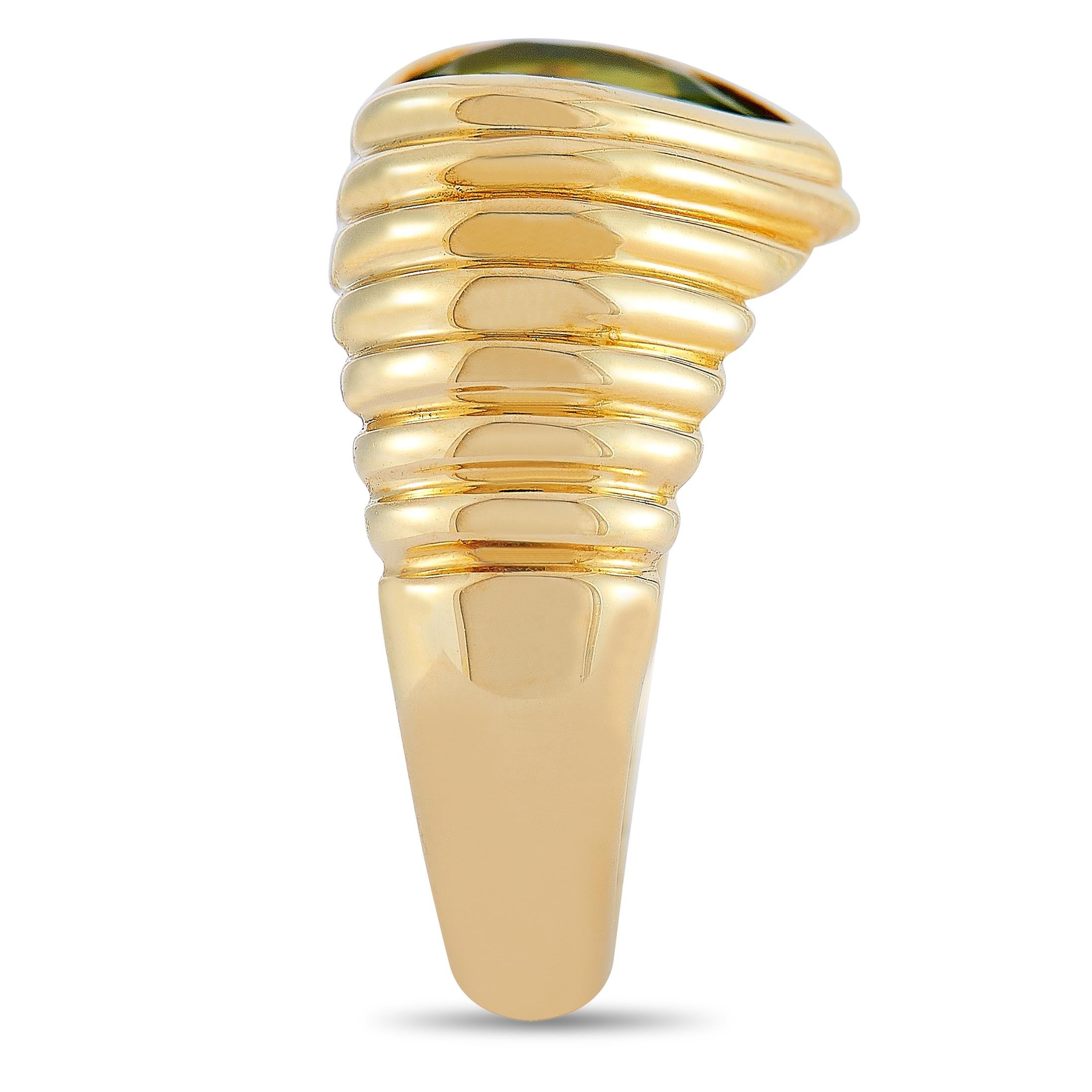 The Bvlgari “Doppio” ring is crafted from 18K yellow gold and weighs 10 grams. It boasts band thickness of 4 mm and top height of 4 mm, while top dimensions measure 10 by 10 mm. The ring is set with a topaz and a peridot.
 
 This item is offered in