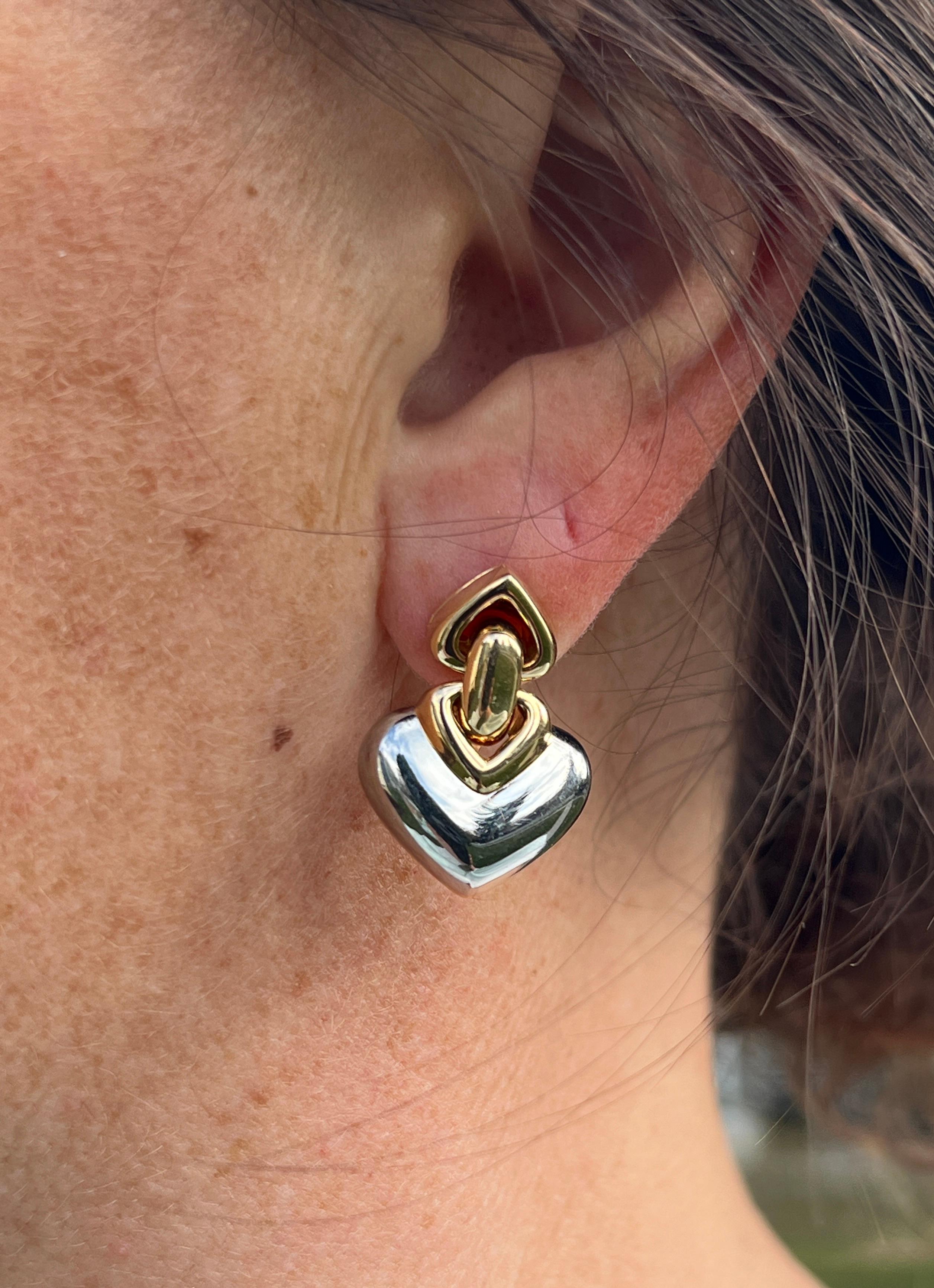 Elevate your jewelry collection with these modern Bvlgari Doppio Cuore heart door knocker earrings, crafted in 18k gold and stainless steel. The design features a playful yet elegant heart motif, stamped with 