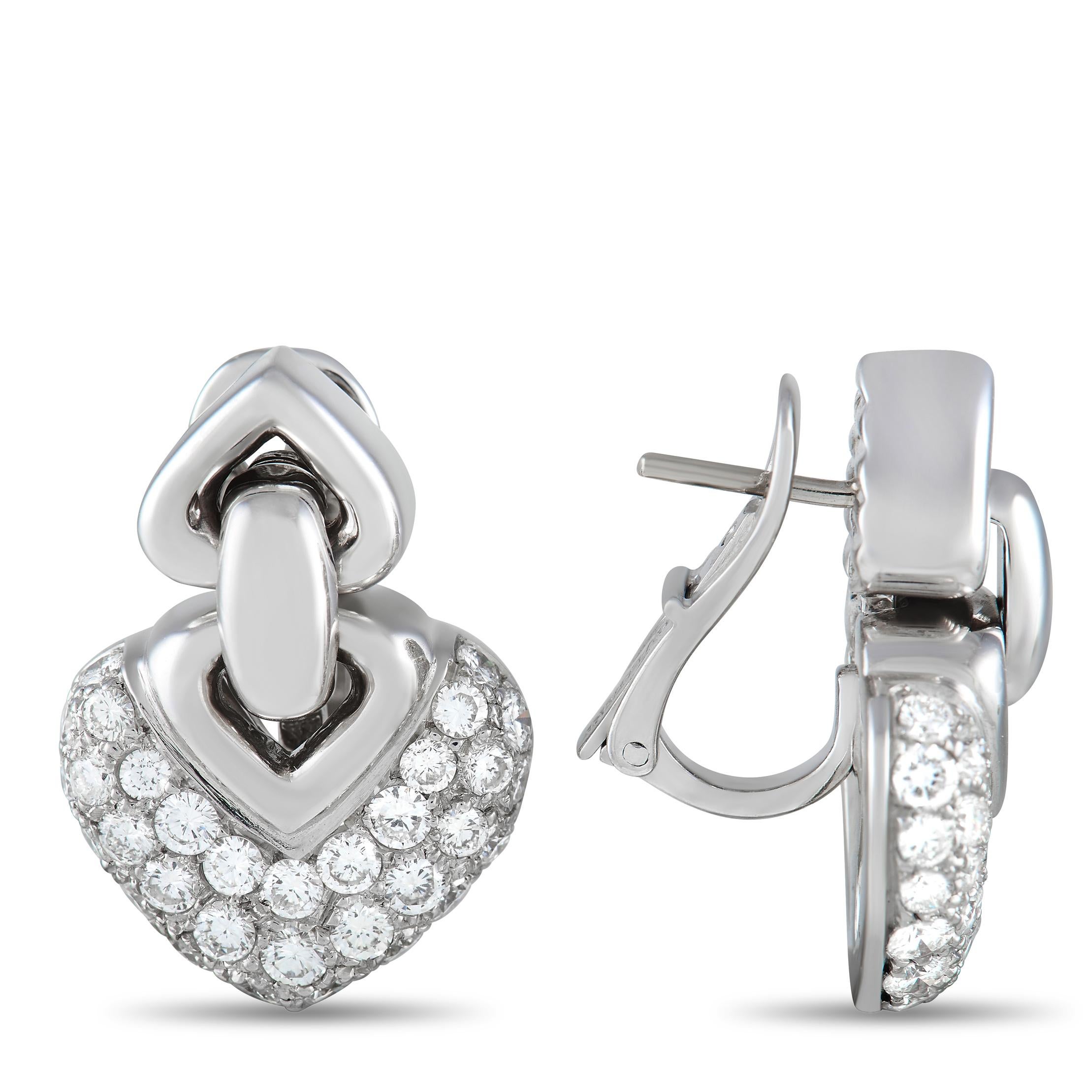 These Bvlgari Doppio Cuore earrings feature a dangling heart-shaped motif covered in pavé diamonds totaling 2.25 carats. Stylish and sophisticated in design, they’re crafted from 18K White Gold for a touch of extra shimmer. Each one measures 1.0”