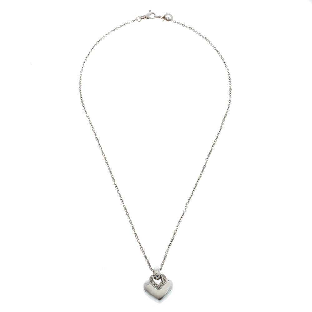 You'll fall in love with this graceful Bvlgari Doppio Cuore necklace. Boasting of great aesthetic, this exquisite piece is forged from 18k white gold and adorned with sparkling diamonds on the heart-shaped pendant. Lend a dash of subtle elegance to