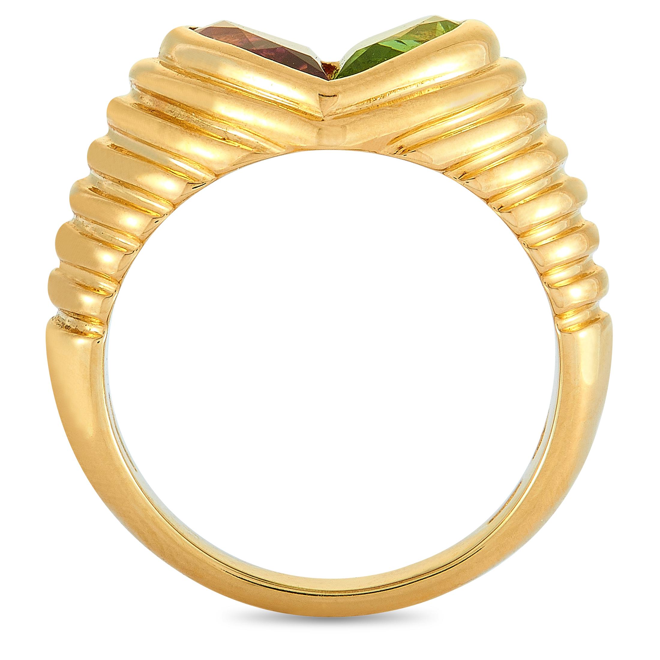 The Bvlgari “Doppio” ring is crafted from 18K yellow gold and set with a peridot and a tourmaline. The ring weighs 10.1 grams, boasting band thickness of 3 mm and top height of 5 mm, while top dimensions measure 10 by 11 mm.
