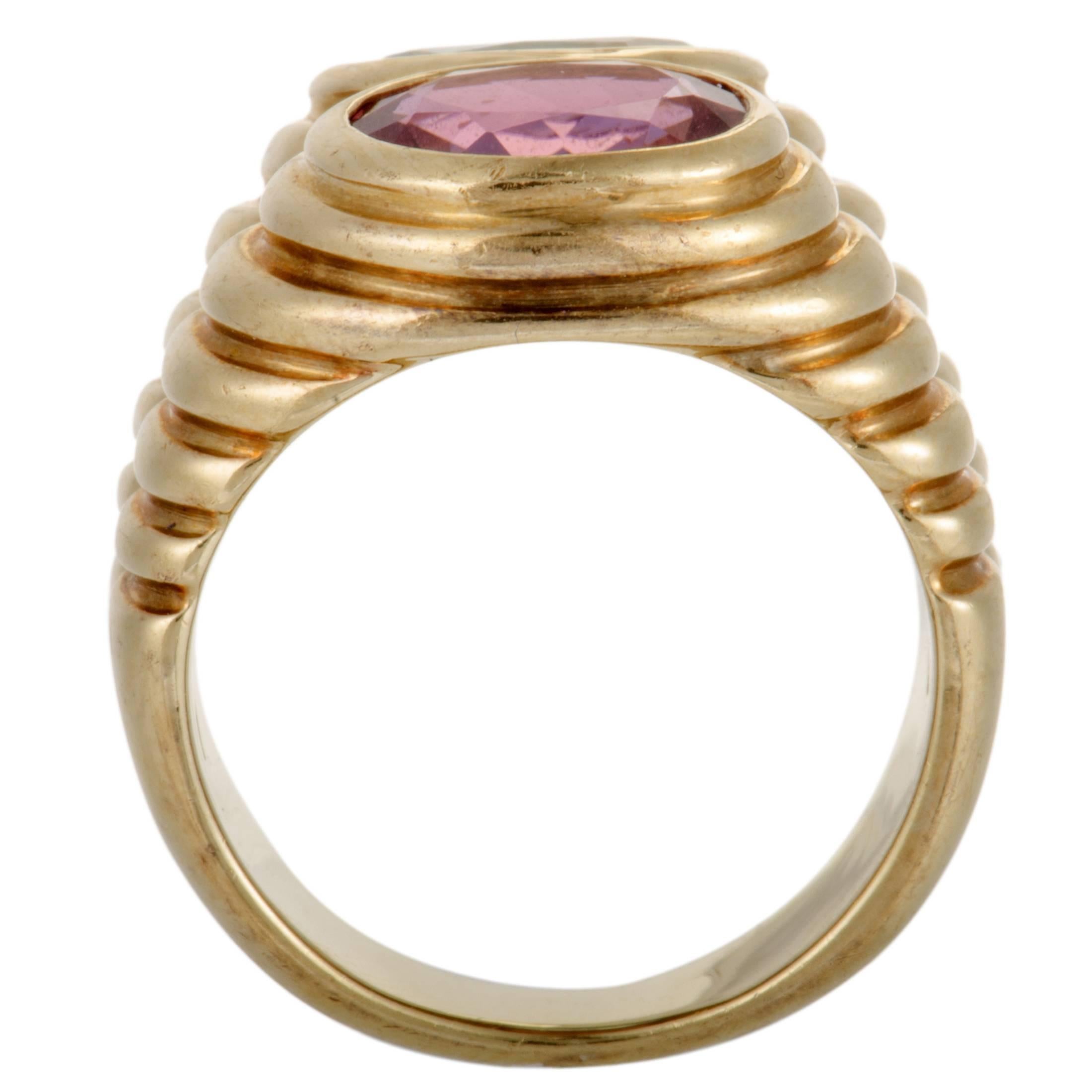 A stunningly unconventional design and an endearingly colorful décor give a gorgeous fashionable appeal to this sublime ring presented by Bvlgari. The ring is made of 18K yellow gold and embellished with topaz and pink tourmaline stones.
Ring Top