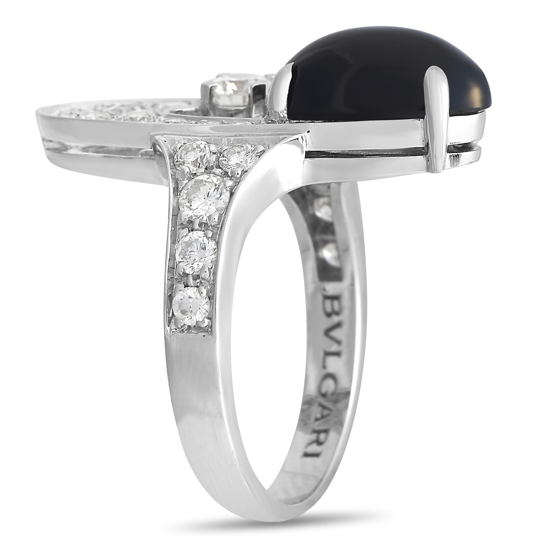 This bold Bvlgari Elisa 18K White Gold Diamond Onyx Ring is sure to attract attention. The ring is made with 18K White Gold and set with a number of round-cut diamonds of assorted sizes over the band and the face of the ring. The lower half of the